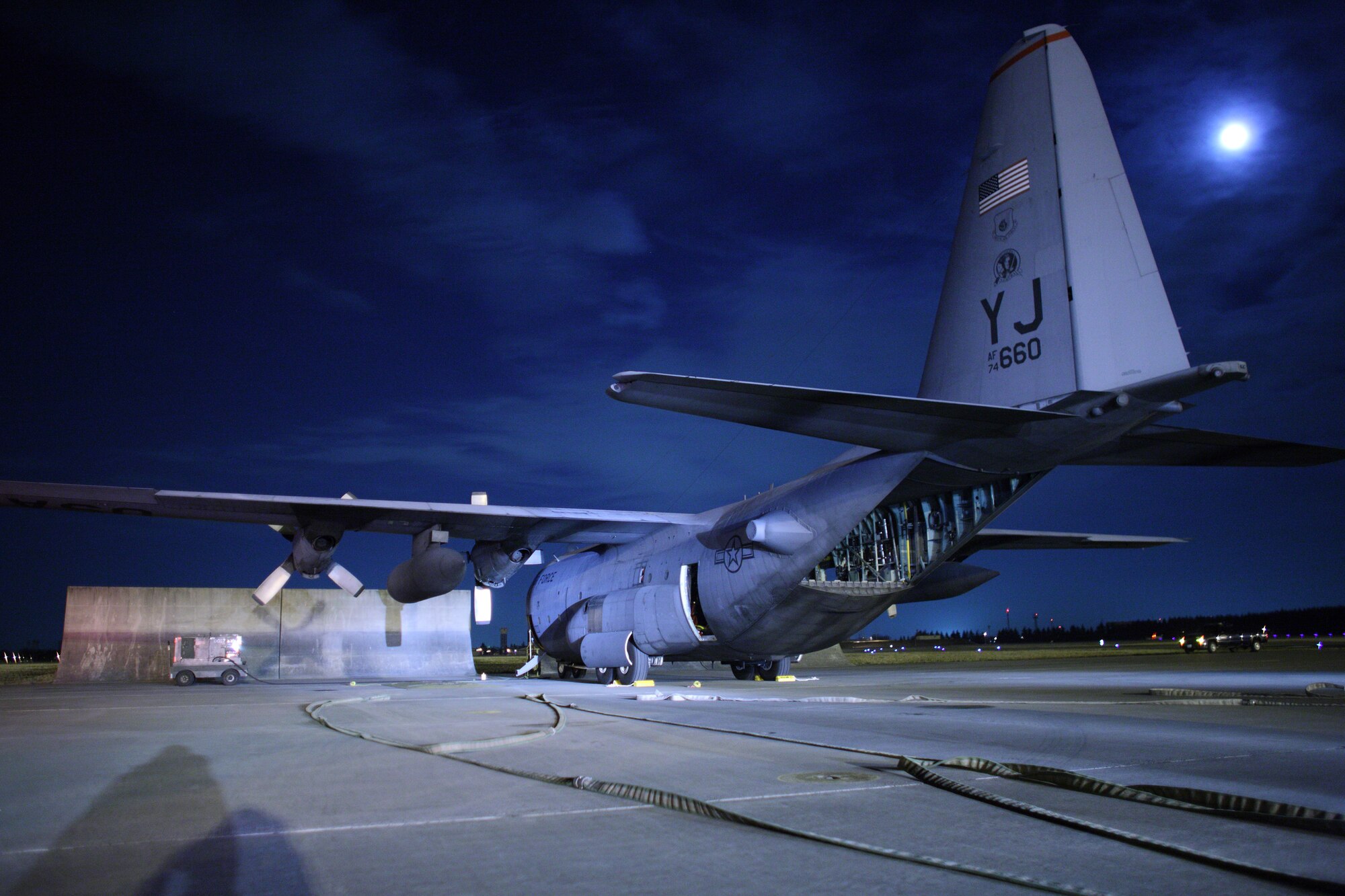 YOKOTA AIR BASE, Japan -- Hoses used to extinguish a simulated fire, lay around a C-130H Hercules here Mar. 31. Yokota conducted an exercise 28 Mar. through 1 Apr. to help maintain operational readiness.  (U.S. Air Force photo/Osakabe Yasuo)