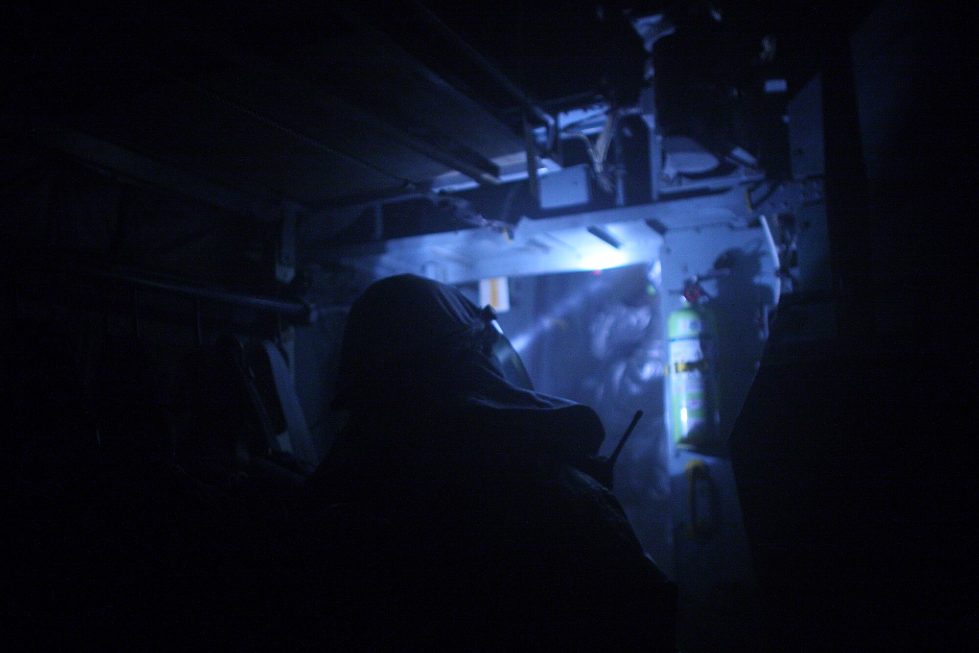 YOKOTA AIR BASE, Japan -- Firefighters from the 374th Civil Engineer Squadron searches a C-130H Hercules exit door due to a simulated fire on the flight deck here March 31. Yokota conducted an exercise 28 Mar. through 1 Apr. to help maintain operational readiness.  (U.S. Air Force photo/Osakabe Yasuo)