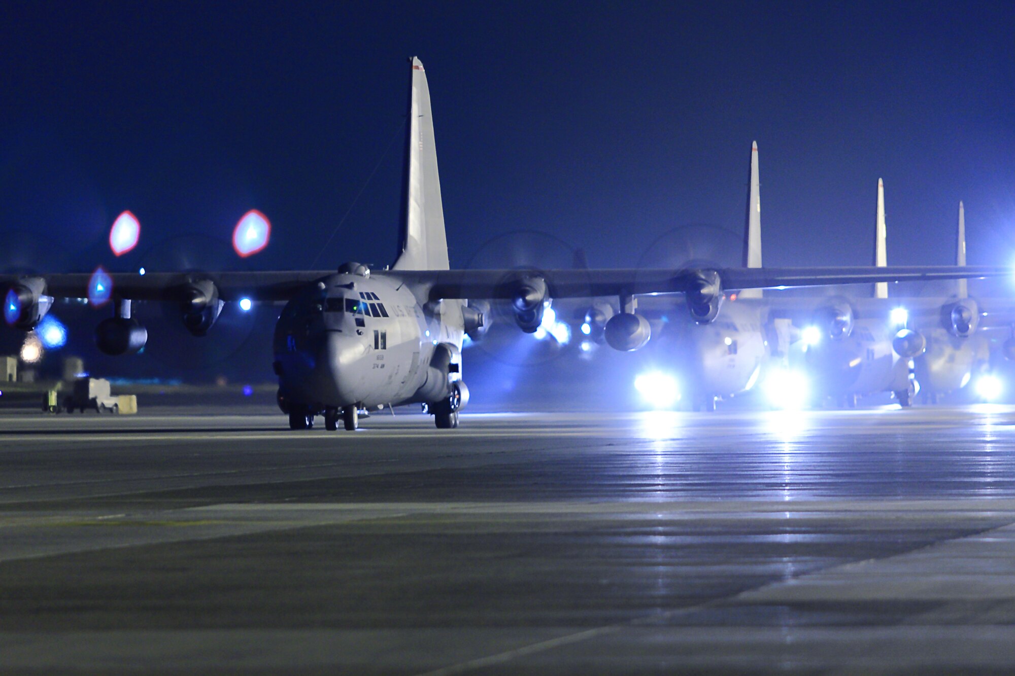 YOKOTA AIR BASE, Japan -- Four C-130H Hercules taxi as part of a 5-ship formation launch here March 31. (U.S. Air Force photo/Osakabe Yasuo)