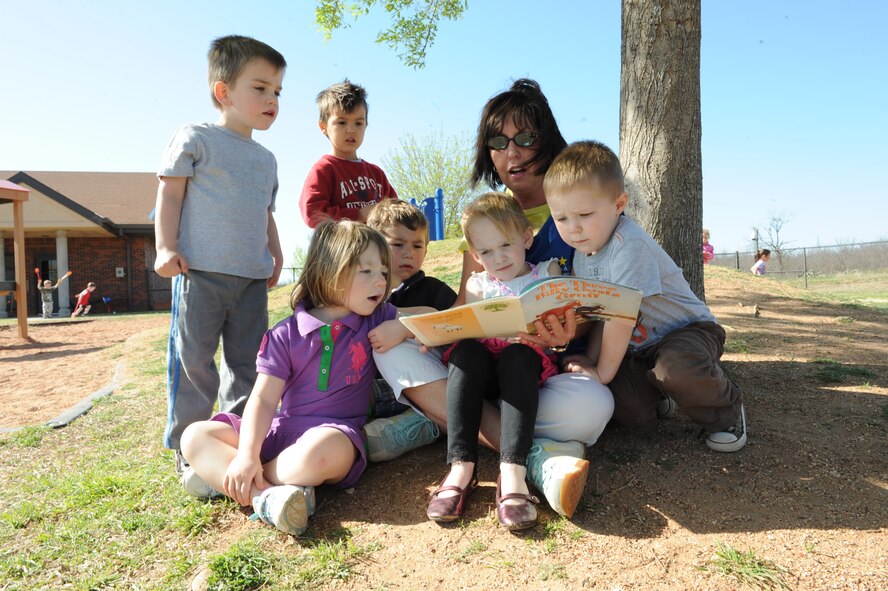DYESS AIR FORCE BASE, Texas – Teresa Tracey, Child Development Center education technician, reads The Three Billy Goats Gruff March 31 to preschool children ages 3 to 5. The CDC recently earned national accreditation from the National Association for the Education of Young Children. (U.S. Air Force photo/ Airman 1st Class Brittney Prescott)