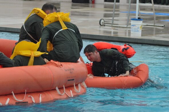 NAVAL AIR STATION KEY WEST, Fla. -- Air Force Reserve Capt. Jay Ference, an instruuctor pilot assigned to the 773rd Airlift Squadron, climbs aboard a 20-person life raft as part of the water survival segment during a training course held here, February 21-22. Capt. Ference and a group of Citizen Airmen from the 910th Airlift Wing, based at Youngstown Air Reserve Station, Ohio attended the survival training course, conducted by Air Force Reservists assigned to the 439th Operational Support Squadron, to fulifill their annual requirement to refresh the skills needed in case their aircraft would go down over land or water. The coursework included segments covering map reading, compass use, food and water procurement, survival vest use, signaling devices and water survival training. U.S. Air Force photo by Master Sgt. Bob Barko Jr.