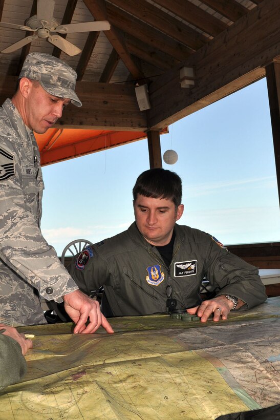 NAVAL AIR STATION KEY WEST, Fla. -- Air Force Reserve Capt. Jay Ference, an instruuctor pilot assigned to the 773rd Airlift Squadron, watches as Senior Master Sgt. Jim Haupt, an Aircrew Flight Equipment specialist assigned to the 910th Operational Support Squadron, points to a map during a survival training course held here, February 21-22. Capt. Ference and a group of Citizen Airmen from the 910th Airlift Wing, based at Youngstown Air Reserve Station, Ohio attended the course, conducted by Air Force Reservists assigned to the 439th Operational Support Squadron, to fulifill their annual requirement to refresh the skills needed in case their aircraft would go down over land or water. The coursework included segments covering map reading, compass use, food and water procurement, survival vest use, signaling devices and water survival training. U.S. Air Force photo by Master Sgt. Bob Barko Jr.