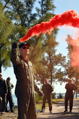 NAVAL AIR STATION KEY WEST, Fla. -- Air Force Reserve Capt. Joe Bennington, a pilot assigned to the 757th Airlift Squadron, demonstrates the use of smoke as a signaling device during a survival training course held here, February 21-22. Capt. Bennington and a group of Citizen Airmen from the 910th Airlift Wing, based at Youngstown Air Reserve Station, Ohio attended the course, conducted by Air Force Reservists assigned to the 439th Operational Support Squadron, to fulifill their annual requirement to refresh the skills needed in case their aircraft would go down over land or water. The coursework included segments covering map reading, compass use, food and water procurement, survival vest use, signaling devices and water survival training. U.S. Air Force photo by Master Sgt. Bob Barko Jr.