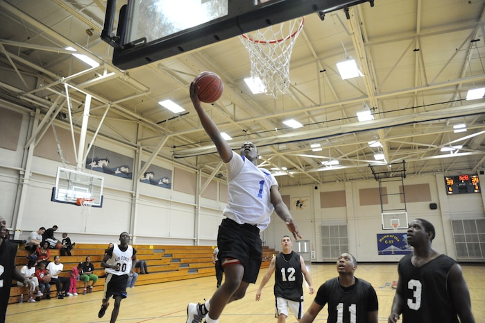 Mark Wheeler attempts a layup during an intramural basketball game held at the Fitness and Sports Center March 30, 2010, at Joint Base Charleston, S.C. The 628th Force Support Squadron beat the 437th Aerial Port Squadron 44-37. Wheeler is with the 628 FSS. (U.S. Air Force photo/James M. Bowman)
