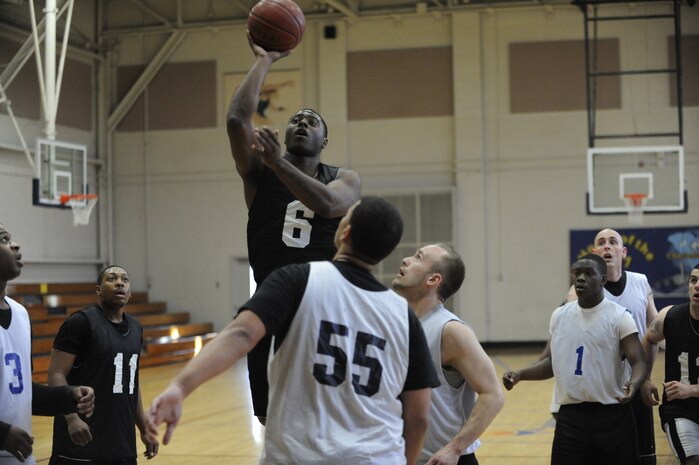 Julius Murray shoots the ball during an intramural basketball game held at the Fitness and Sports Center March 30, 2010, at Joint Base Charleston, S.C. The 628th Force Support Squadron beat the 437th Aerial Port Squadron 44-37. Sixteen teams started off the competition for the base championship during this season, which will come to an end in early April. Murray is with the 437 APS. (U.S. Air Force photo/James M. Bowman)