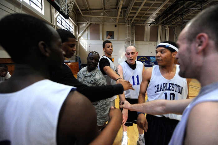 Members of the 628th Force Support Squadron basketball team come together during an intramural basketball game at the Fitness and Sports Center March 30, 2010, at Joint Base Charleston, S.C. The 628th Force Support Squadron beat the 437th Aerial Port Squadron 44-37. Sixteen teams started off the competition for the base championship during this season, which will come to an end in early April. (U.S. Air Force photo/James M. Bowman)