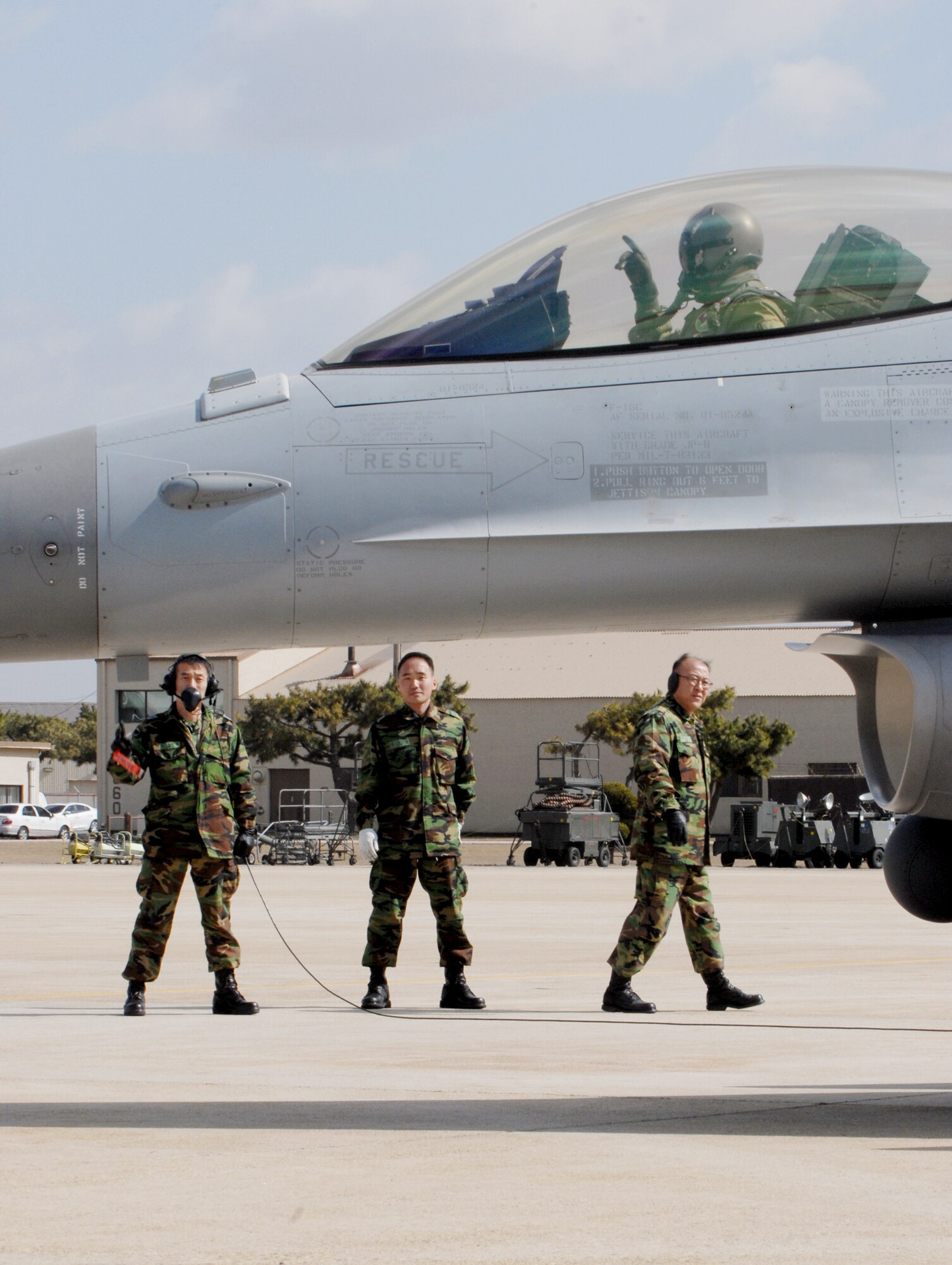 South Korea air force crew chiefs perform one last preflight check during an exercise March 16, 2010, at Kunsan Air Base, South Korea. The exercise places U.S. and South Korea air force pilots together for several realistic aerial exercises to familiarize with each other's tactics and procedures. (U.S. Air Force photo/Senior Airman Roy Lynch)
