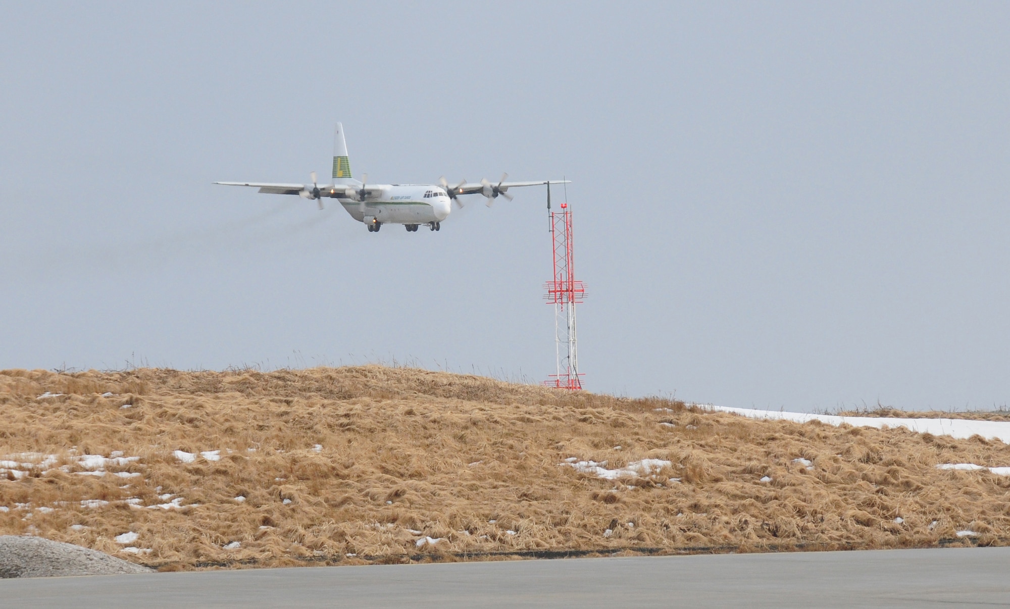 A Lynden Air Cargo L-100 lands at Eareckson Air Station March 23. The weather on Shemya Island, Alaska changes at a moment’s notice. This final approach was welcomed by a snowstorm which passed before the aircraft was unloaded 15 minutes later. (Air Force photo by Capt. Uriah Orland)