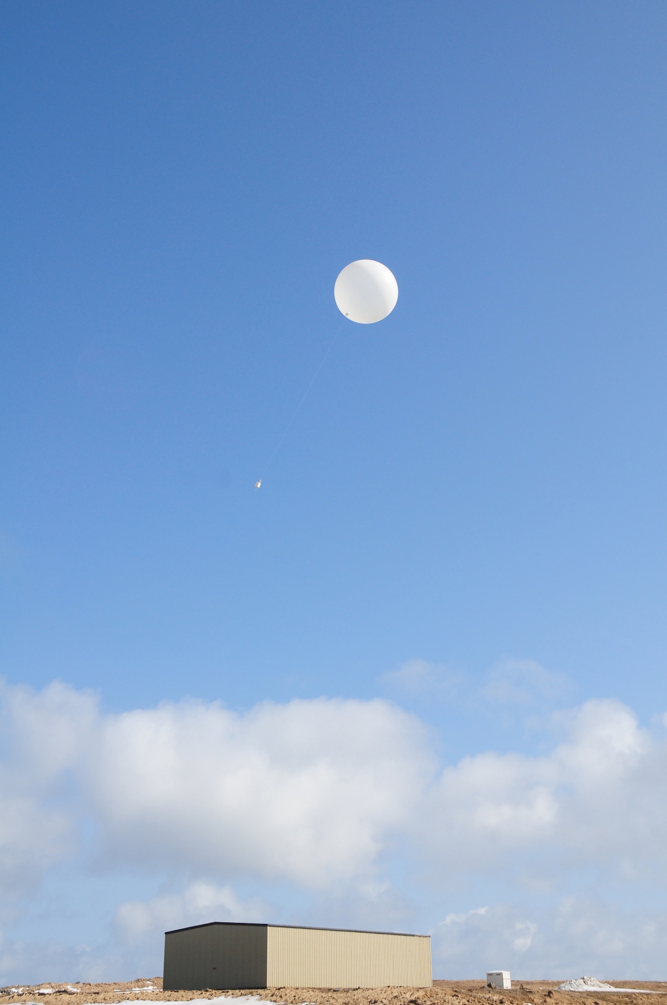 A weather balloon drifts skyward from Eareckson Air Station, Shemya Island, Alaska, March 23. Attached to the balloon is a radiosonde weather sensor used to collect temperature, winds aloft, pressure based on altitude and the dew point. (Air Force photo by Capt. Uriah Orland)