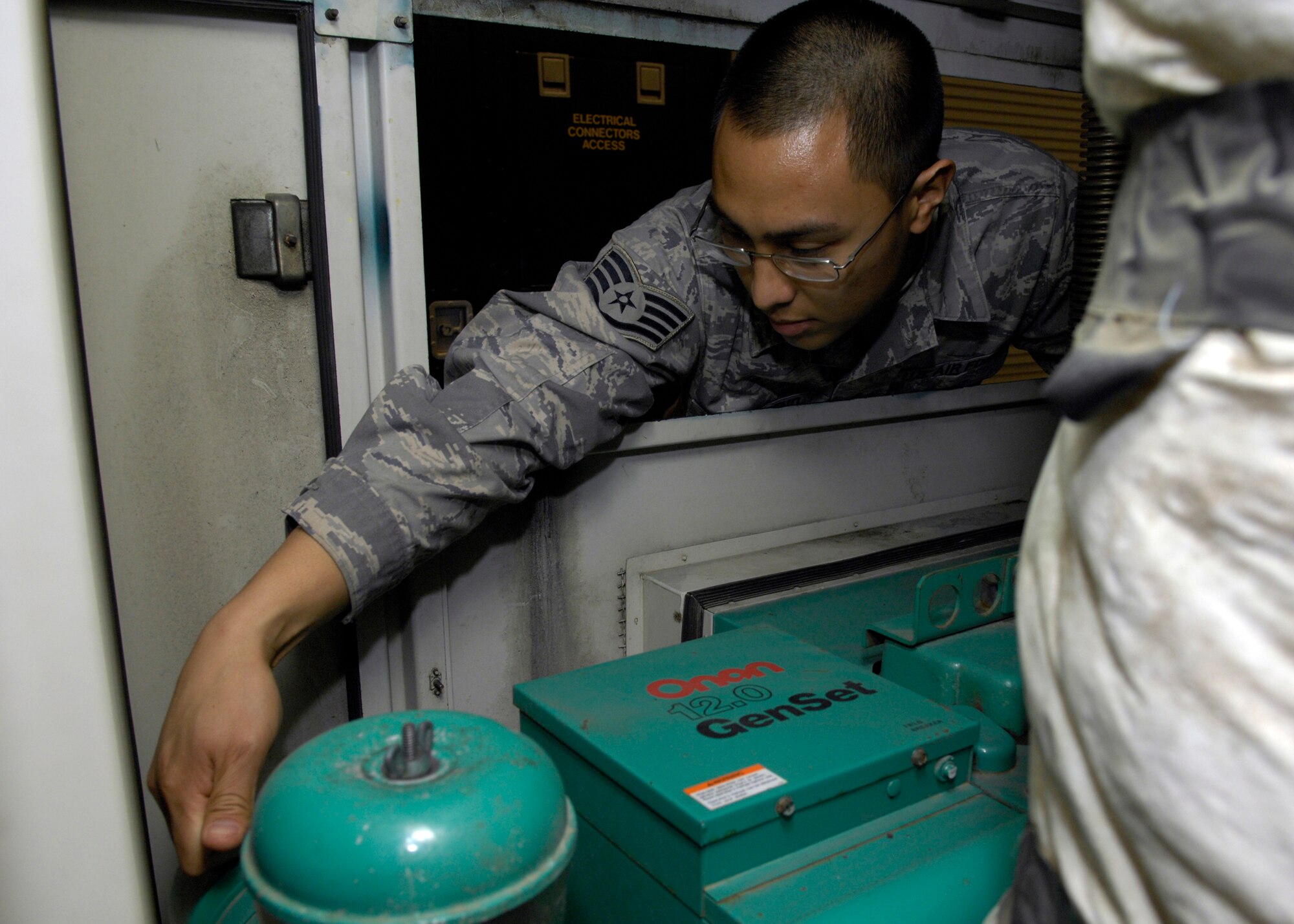 VANDENBERG AIR FORCE BASE, Calif. -- Reaching into the portable air conditioner, Staff Sgt. Randy Nepomuceno, of the 576th Flight Test Squadron, examines the working conditions of the engine here Thursday, March 11, 2010. The PAC is specifically designed to be used when the missile is in the missile well and some piece of equipment needs further testing in a cooler environment. (U.S. Air Force photo/Airman 1st Class Lael Huss)