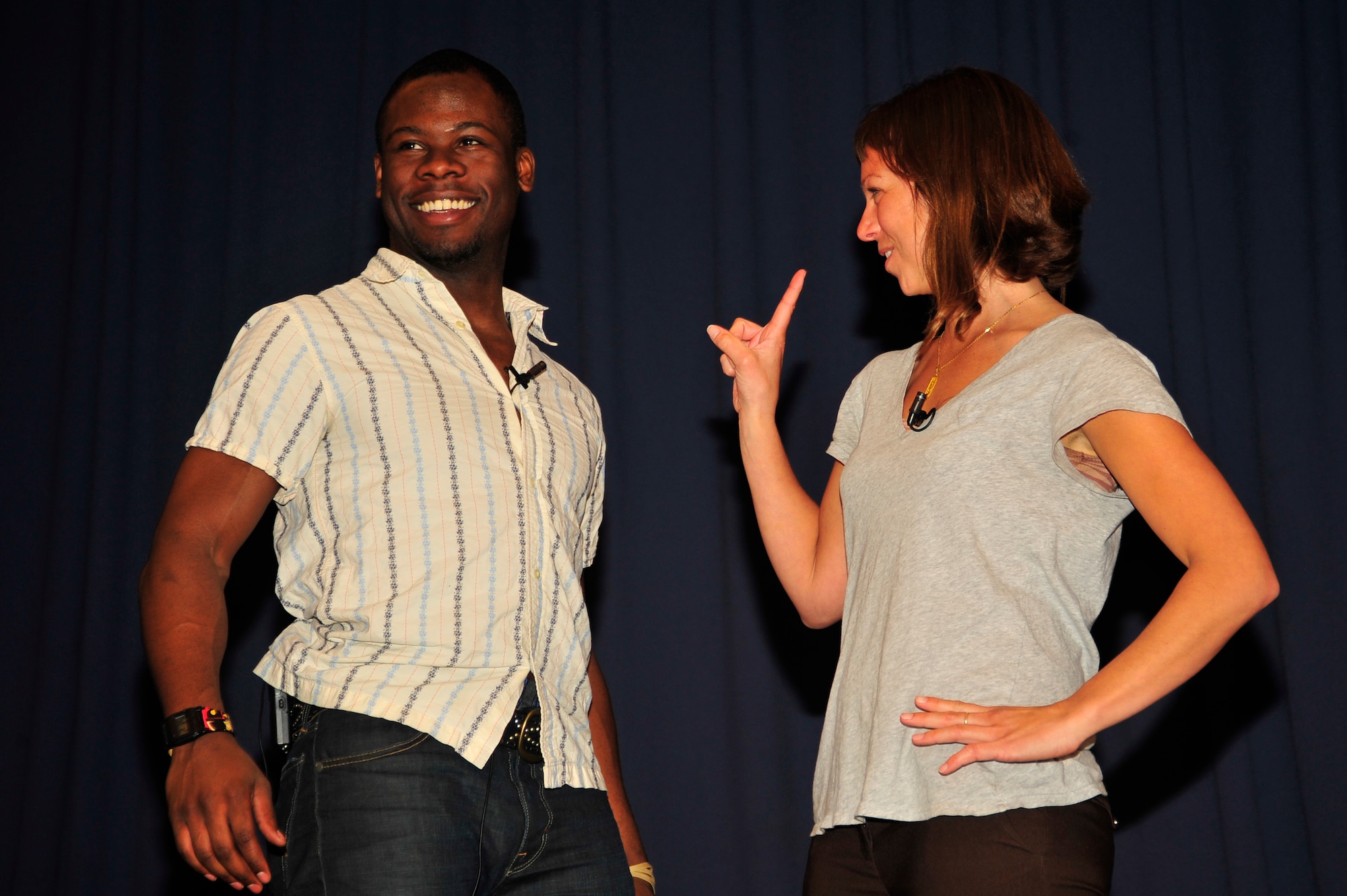Performers Kyle Terry, left, and Amber Kelly, right, portray a dating scene during the "Sex Signals" presentation at the Hurlburt Field Commando Auditorium March 29.  “Sex Signals” is an improvised, two-person presentation geared to educate Airmen about the stereotypes and misconceptions surrounding sexual assault. (U.S. Air Force photo by Senior Airman Matthew Loken)