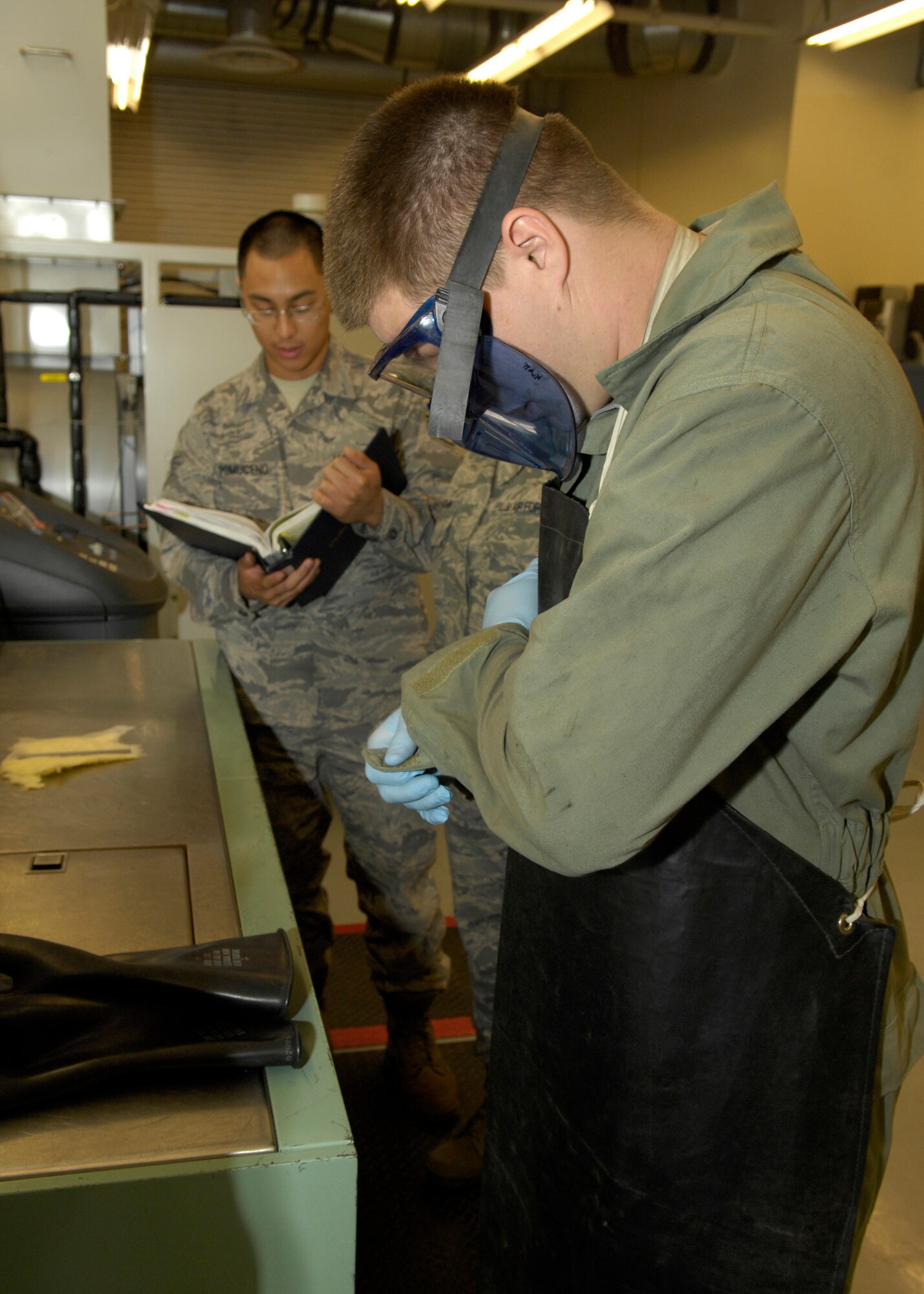 VANDENBERG AIR FORCE BASE, Calif.-- Suiting up, Staff Sgt. Anthony Klatt, of the 576th Flight Test Squadron, puts on protective gear before turning on the guidance and control test bench here Thursday, March 11, 2010. Sergeant Klatt is a facility maintainer whose primary mission is "dedicated to professionally executing tests that accurately measure the current and future capabilities of the nation's ICBM force." (U.S. Air Force photo/Airman 1st Class Lael Huss)