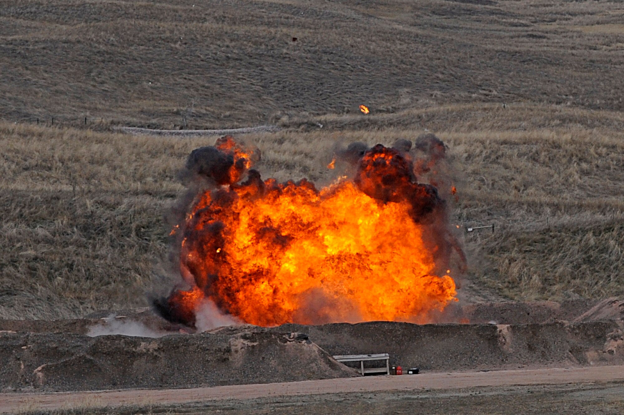 ELLSWORTH AIR FORCE BASE, S.D. -- A controlled explosion takes place at the bomb range during a routine training exercise by explosive ordnance disposal personnel, March 30. The training consisted of multiple controlled explosions to maintain combat readiness. (U.S. Air Force photo/Airman 1st Class Matthew Flynn)

