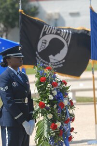 Senior Airman Monik Williams, a Randolph Air Force Base, TX, Honor Guard member, stands guard after posting the memorial wreath for the Freedom Flyers Reunion of former Viet Nam Prisoners of War in front of the Missing Man Monument March 26, 2010. (U.S. Air Force photo by Steve White)