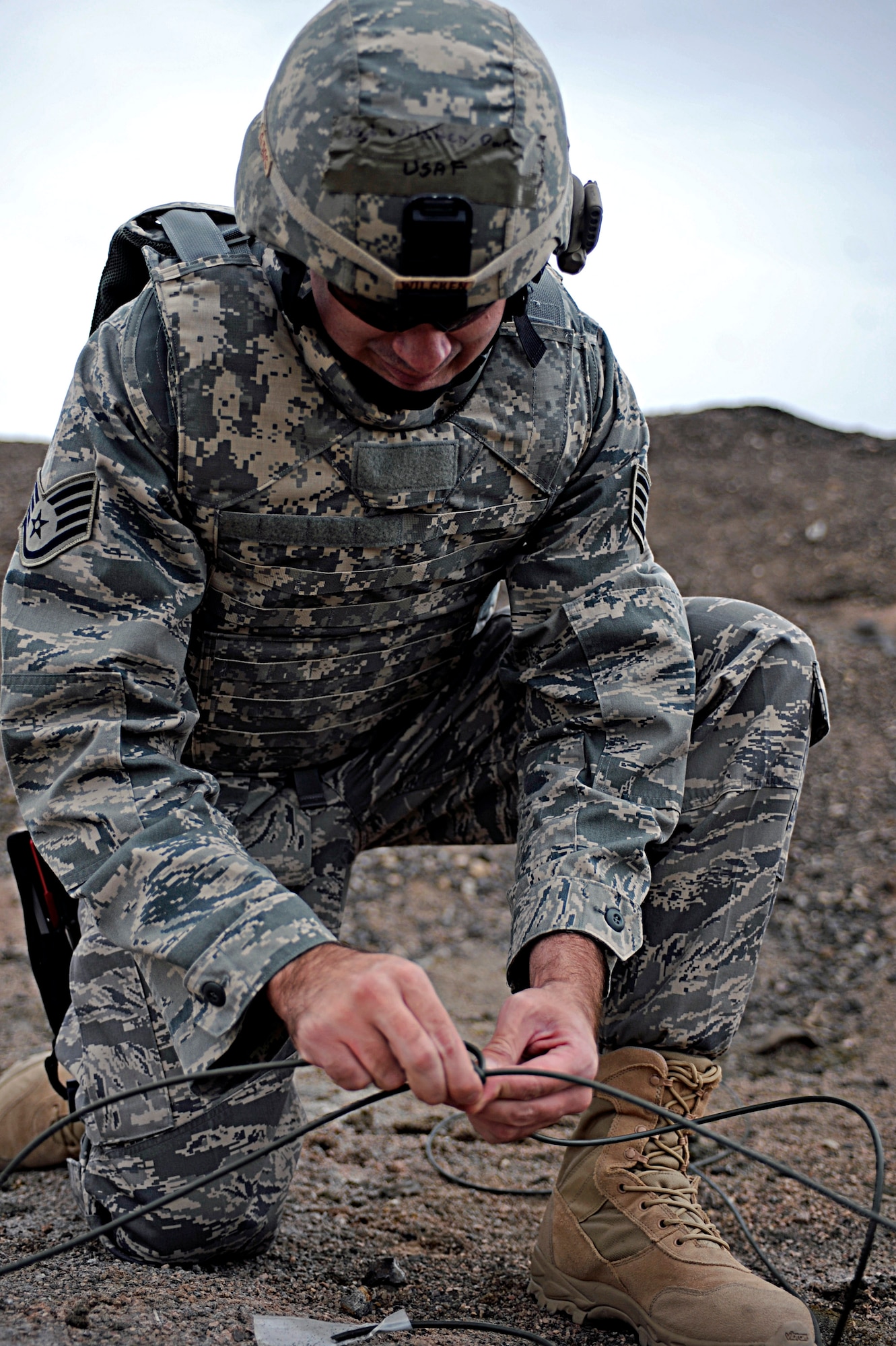 ELLSWORTH AIR FORCE BASE, S.D. -- Staff Sgt. Darryl Wilcken, 28th Civil Engineer Squadron explosive ordnance disposal journeyman, connects separate detonation cords together, March 30. Sergeant Wilcken is preparing a controlled main-line detonation during a routine training exercise. (U.S. Air Force photo/Airman 1st Class Matthew Flynn)