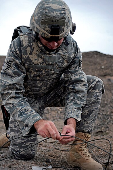 ELLSWORTH AIR FORCE BASE, S.D. -- Staff Sgt. Darryl Wilcken, 28th Civil Engineer Squadron explosive ordnance disposal journeyman, connects separate detonation cords together, March 30. Sergeant Wilcken is preparing a controlled main-line detonation during a routine training exercise. (U.S. Air Force photo/Airman 1st Class Matthew Flynn)