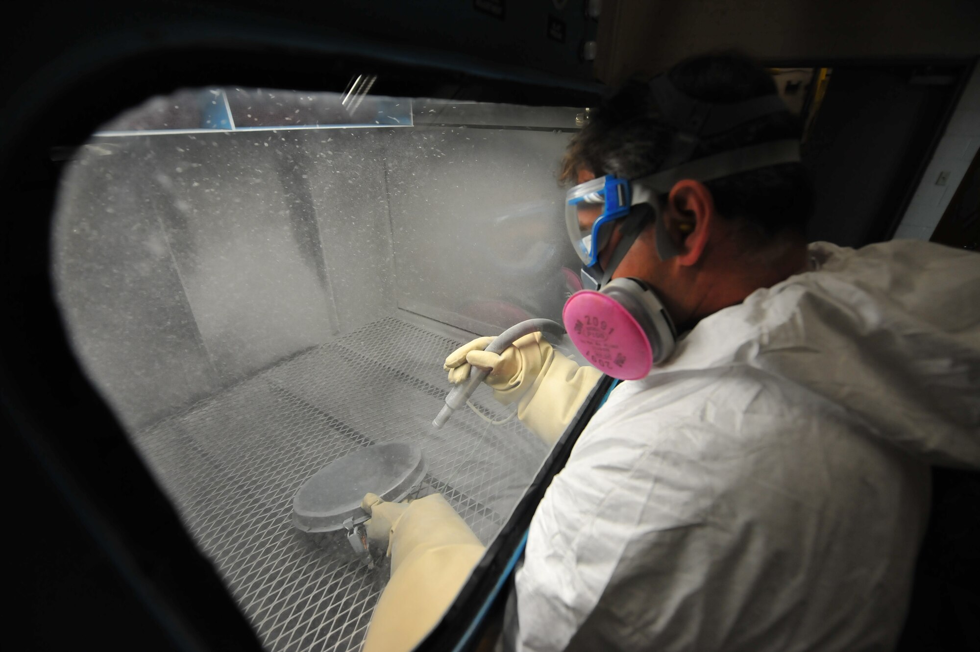 MINOT AIR FORCE BASE, N.D. -- Greg Wiggins, 91st Missile Maintenance Squadron corrosion control technician, bead blasts a cover plate to remove surface corrosion at the 91st MMXS corrosion control facility on Minot AFB March 16. Bead blasting is part of the prepping process before parts are ready to be re-painted.  The 91st MMXS corrosion control shop maintains and helps to extend the surface life of all equipment used to support 91st Missile Wing operations.  They not only repair corrosion in-garrison, but they are also mobile and take their equipment into the field to repair corrosion at all 150 missile sites. (U.S. Air Force photo by Master Sgt. Michael Gaddis)
