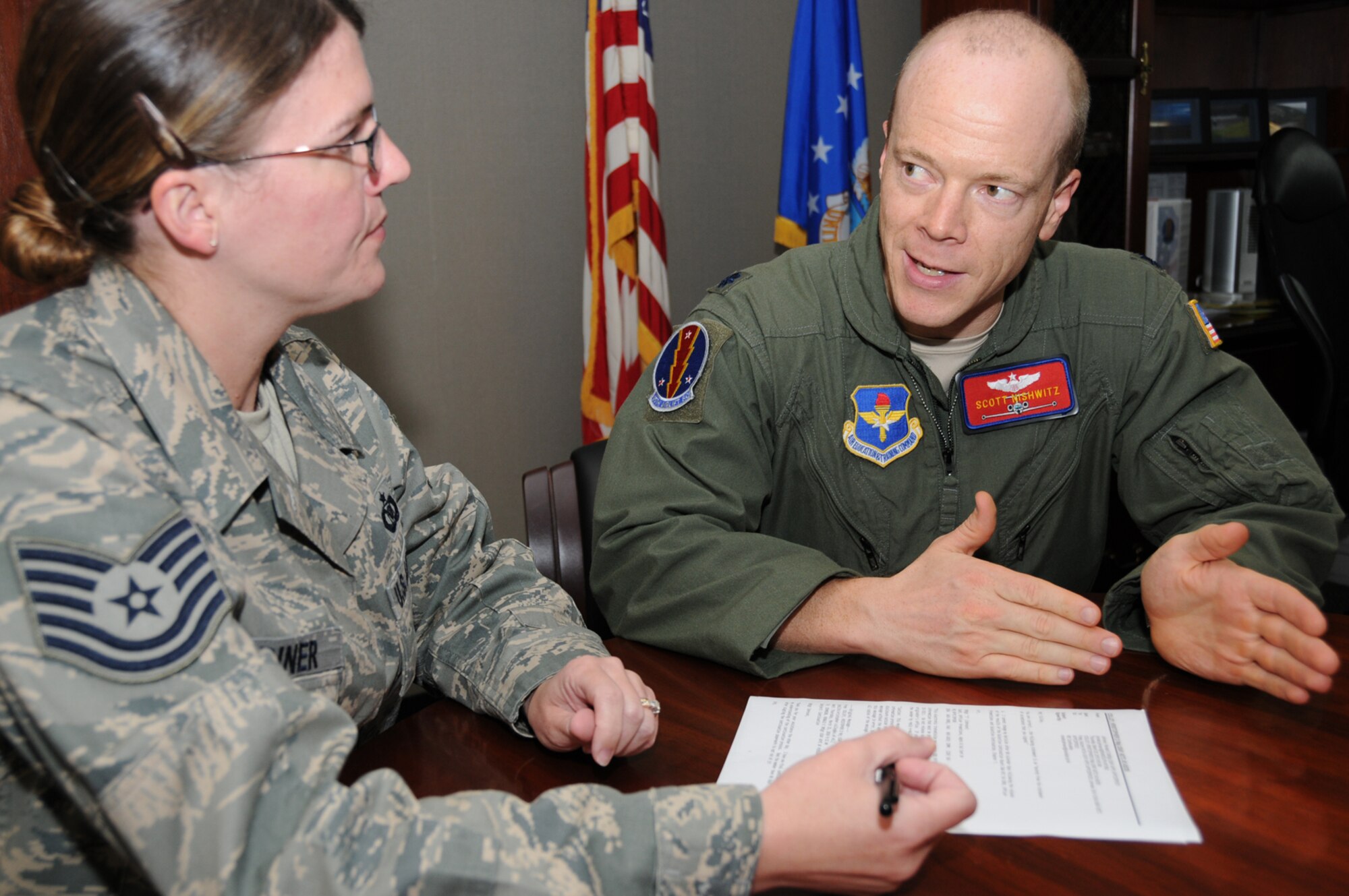 Tech. Sgt. Jennifer Wariner, left, and Lt. Col. Scott Nishwitz, new commander of the 45th Airlift Squadron, review deployment information on one of the squadron’s members March 25 at Lott Hall.  Colonel Nishwitz, who took command from Lt. Col. Jimmy Canlas March 22, formerly served as the squadron’s director of operations.  Colonel Canlas, who directed the unit since May 2008, moves to the Pentagon to serve as an executive officer on the Air Staff.  (U.S. Air Force photo by Kemberly Groue)