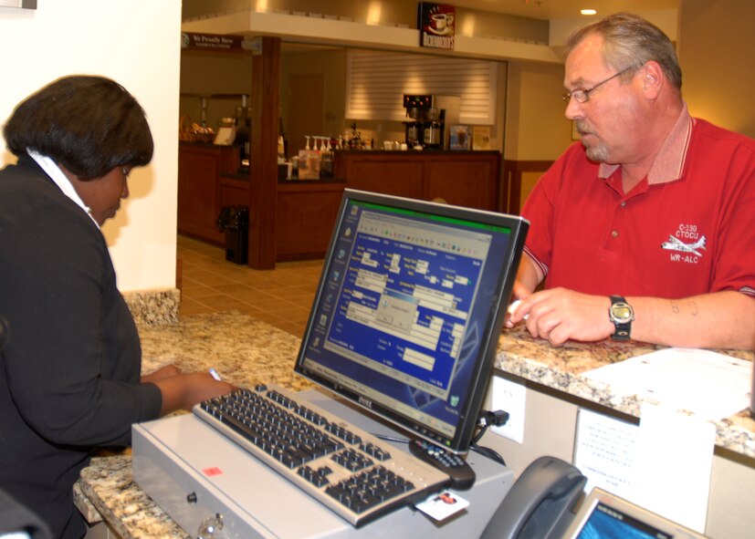Adrienne Jackson, Commando Inn guest services employee, assists a customer checking in to the new Soundside Lodging Facility March 30. The new facility opened March 28 after two years of construction, increasing the rooms available to visitors from 123 to 243.(U.S. Air Force photo by Senior Airman Ryan Whitney) 