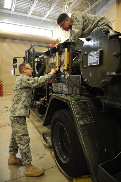 DYESS AIR FORCE BASE, Texas – Senior Airman Jeremiah Hunter (left) and Senior Airman Mark Gutierrez, 7th Logistics Readiness Squadron refueling maintenance technicians, replace gages on a fuel truck here, March 30. The gages must be turned in to the Precision Management Equipment Laboratory for calibration before being replaced. (U.S. Air Force photo/ Airman 1st Class Brittney Prescott)