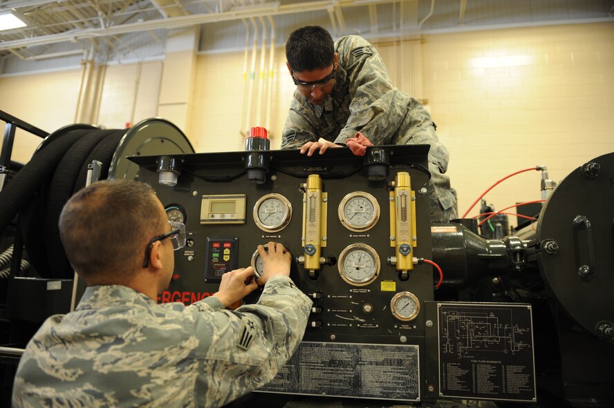 DYESS AIR FORCE BASE, Texas – Senior Airman Jeremiah Hunter (left) and Senior Airman Mark Gutierrez, 7th Logistics Readiness Squadron refueling maintenance technicians, replace gages on a fuel truck here, March 30. The gages must be turned in to the Precision Management Equipment Laboratory for calibration before being replaced. (U.S. Air Force photo/ Airman 1st Class Brittney Prescott)