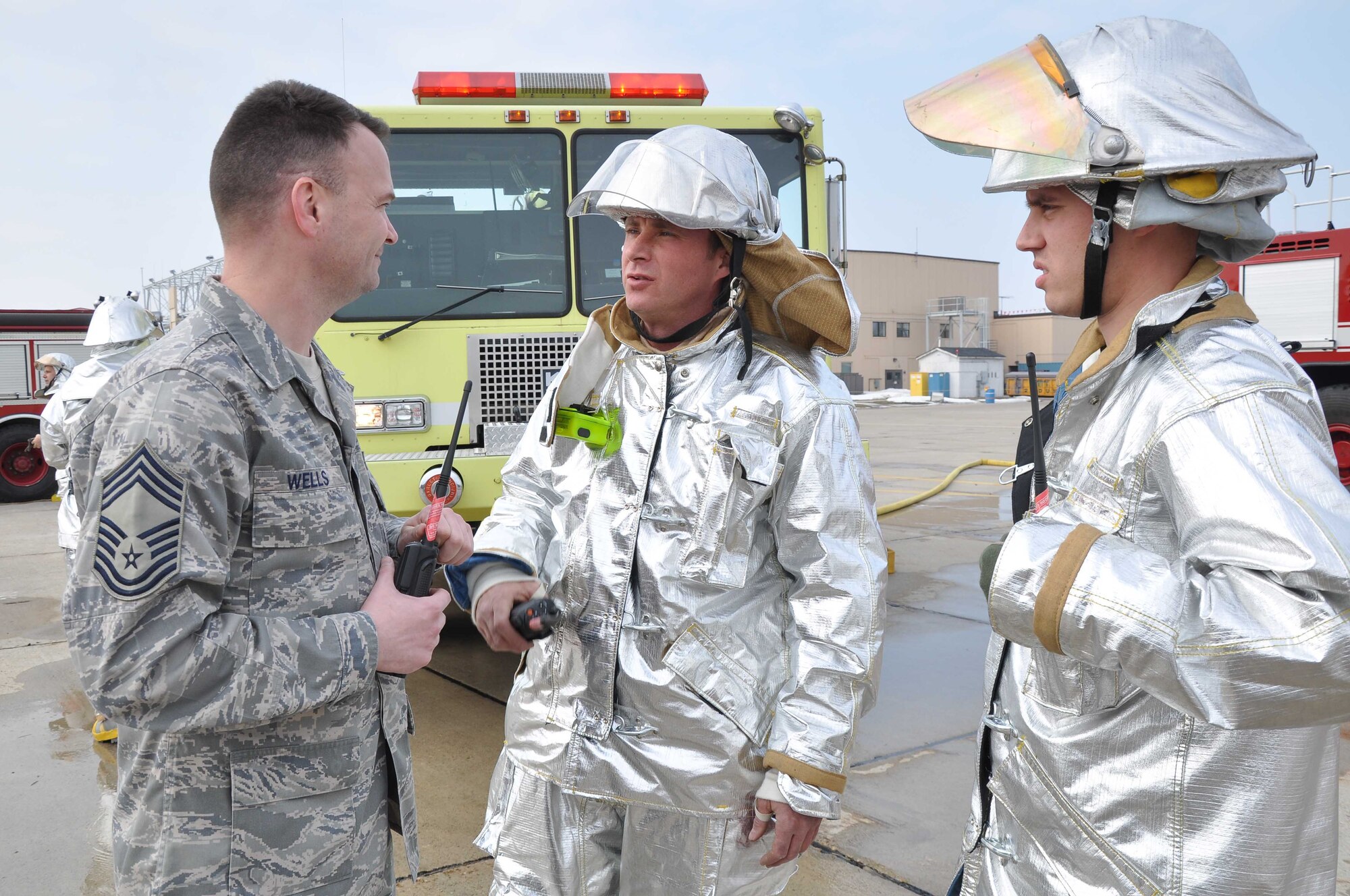 Chief Master Sgt. David Wells, (left) 22nd Air Force fire chief, talks with Senior Airman Casey Jones, 934th Civil Engineer Squadron, during the Staff Assistance Visit March 7. (Air Force Photo/Tech. Sgt. Bob Sommer)