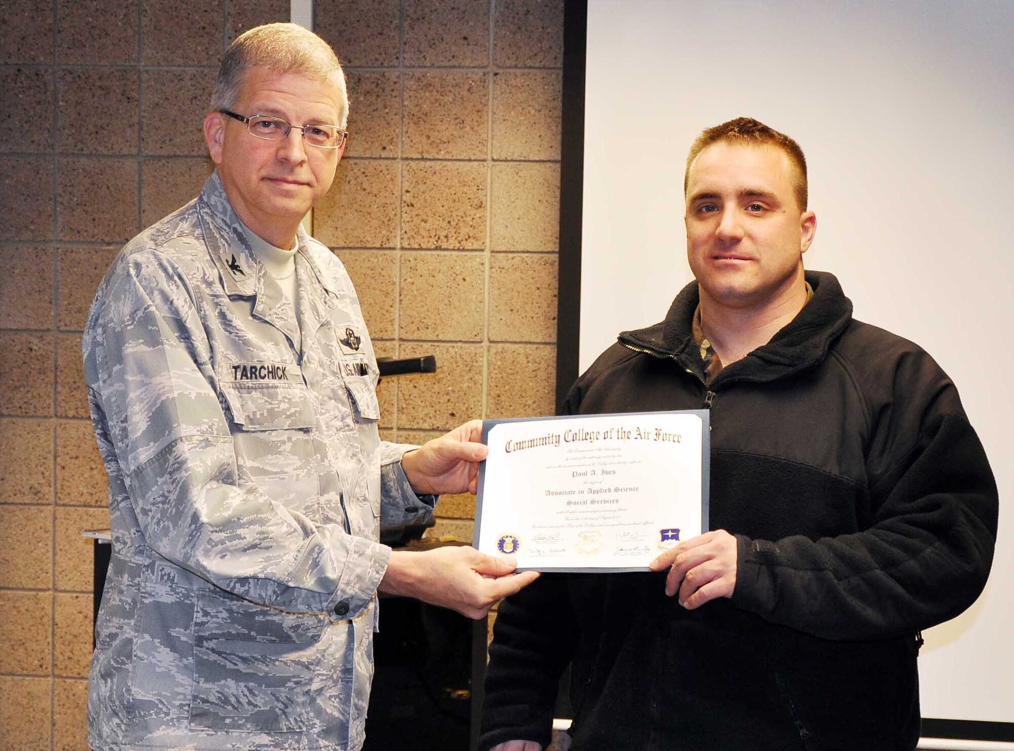 Chief Master Sgt. David Wells, (left) 22nd Air Force fire chief, talks with Senior Airman Casey Jones, 934th Civil Engineer Squadron, during the Staff Assistance Visit March 7. 