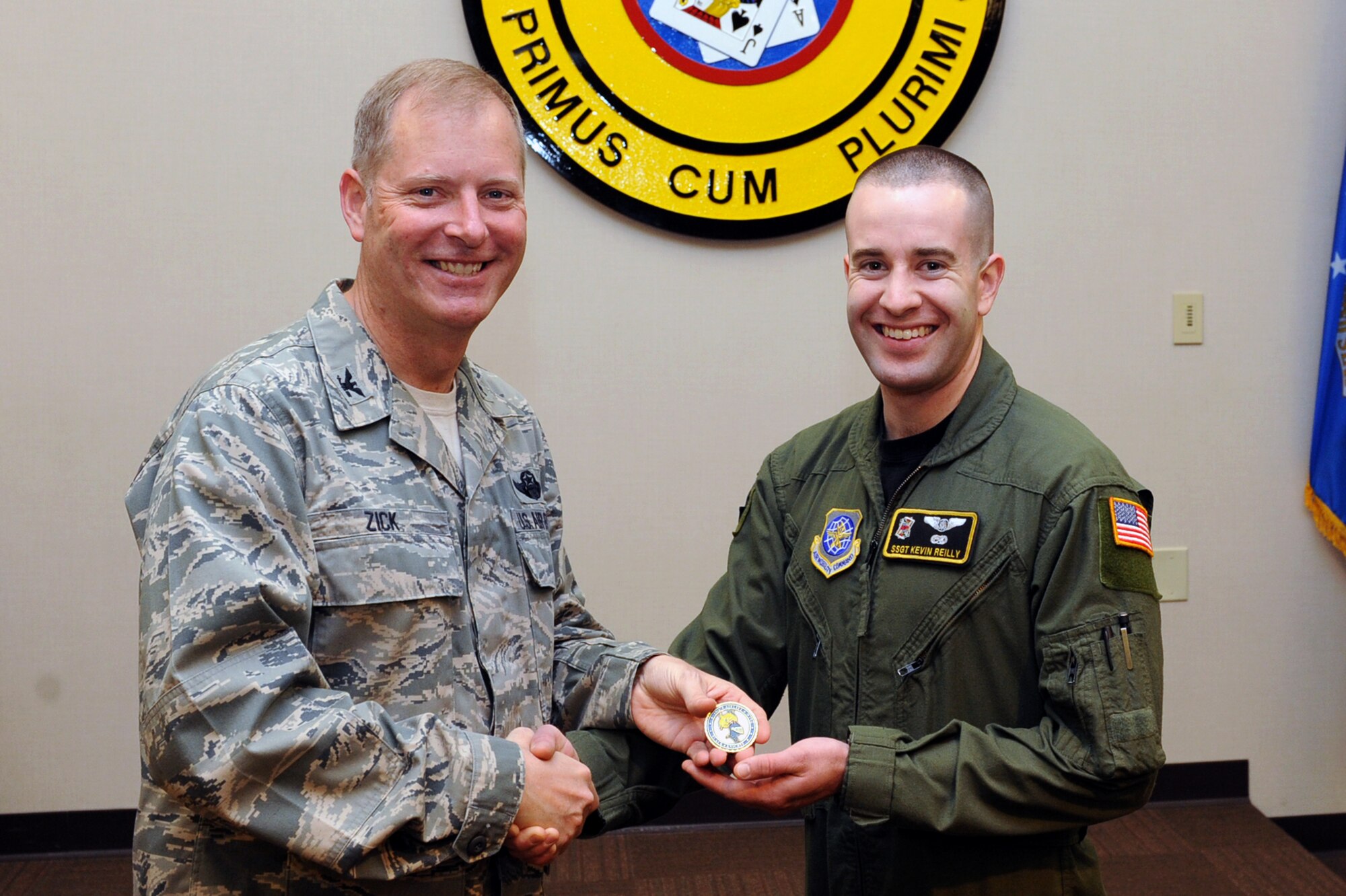 Col. Michael Zick, 19th Airlift Wing vice commander, presents a coin to Staff Sgt. Kevin Reilly, 53rd Airlift Squadron flight engineer, March 31 at the 53rd AS auditorium for his selection as the Combat Airlifter of the Week. Sergeant Reilly was selected as the 19th Airlift Wing point of contact for the March command run and led a team of 30 personnel, coordinating all aspects of the 1,800-participant event. He was also the 53rd AS enlisted representative for the Air Force Assistance Fund, ensuring 100 percent contact with squadron members, raising more than $5,000 for Air Force charities. (U.S. Air Force photo by Senior Airman Ethan Morgan)