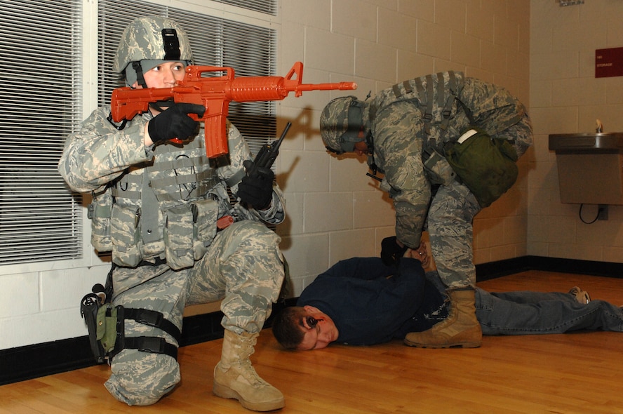 MINOT AIR FORCE BASE, N.D. -- Staff Sgt. Jarrod Nelson, 5th Security Forces Squadron fire team leader, provides security while another member of the team detains a possible shooter in the McAdoo Sports and Fitness Center during a major accident response exercise March 26. Exercises like this provide the installation commander a way to conduct realistic exercises for all installation personnel. (U.S. Air Force photo by Airman 1st Class Aaron-Forrest Wainwright)