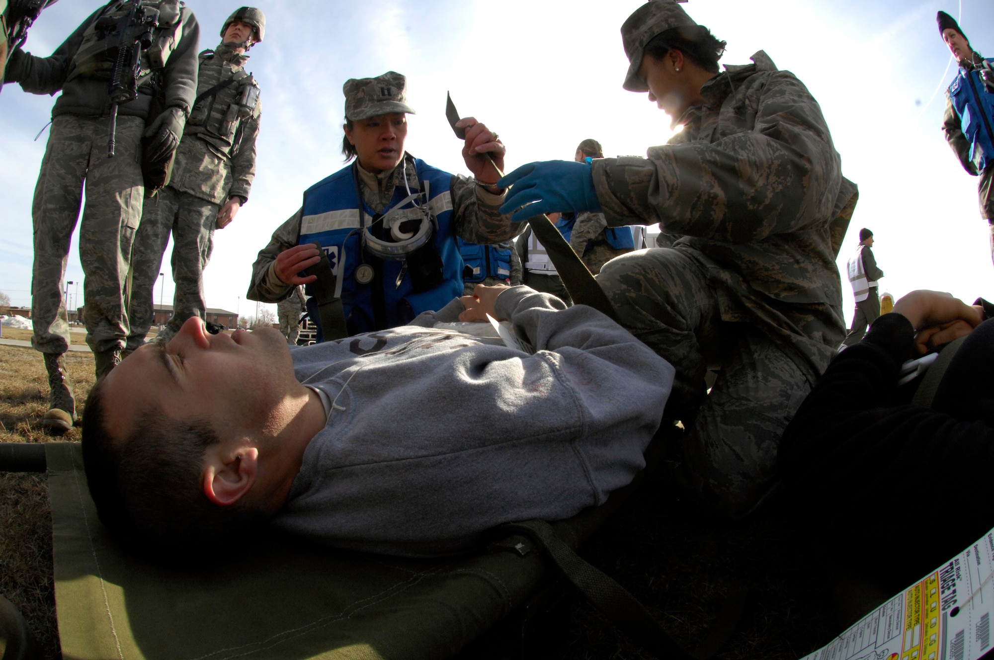 MINOT AIR FORCE BASE, N.D. – Capt. Tomao Rose and Senior Airman Erika Jenkins, both 5th Medical Operations Squadron physicians, assess and treat Airman 1st Class Thomas Kennedy, 91st Missile Maintenance Squadron periodic maintenance team member and “simulated victim”, during the major accident response exercise at Minot AFB March 26. Exercises like this MARE prepare base personnel for possible real-world situations as well as testing communication and emergency procedures. (U.S. Air Force photo by Senior Airman Jesse Lopez)
