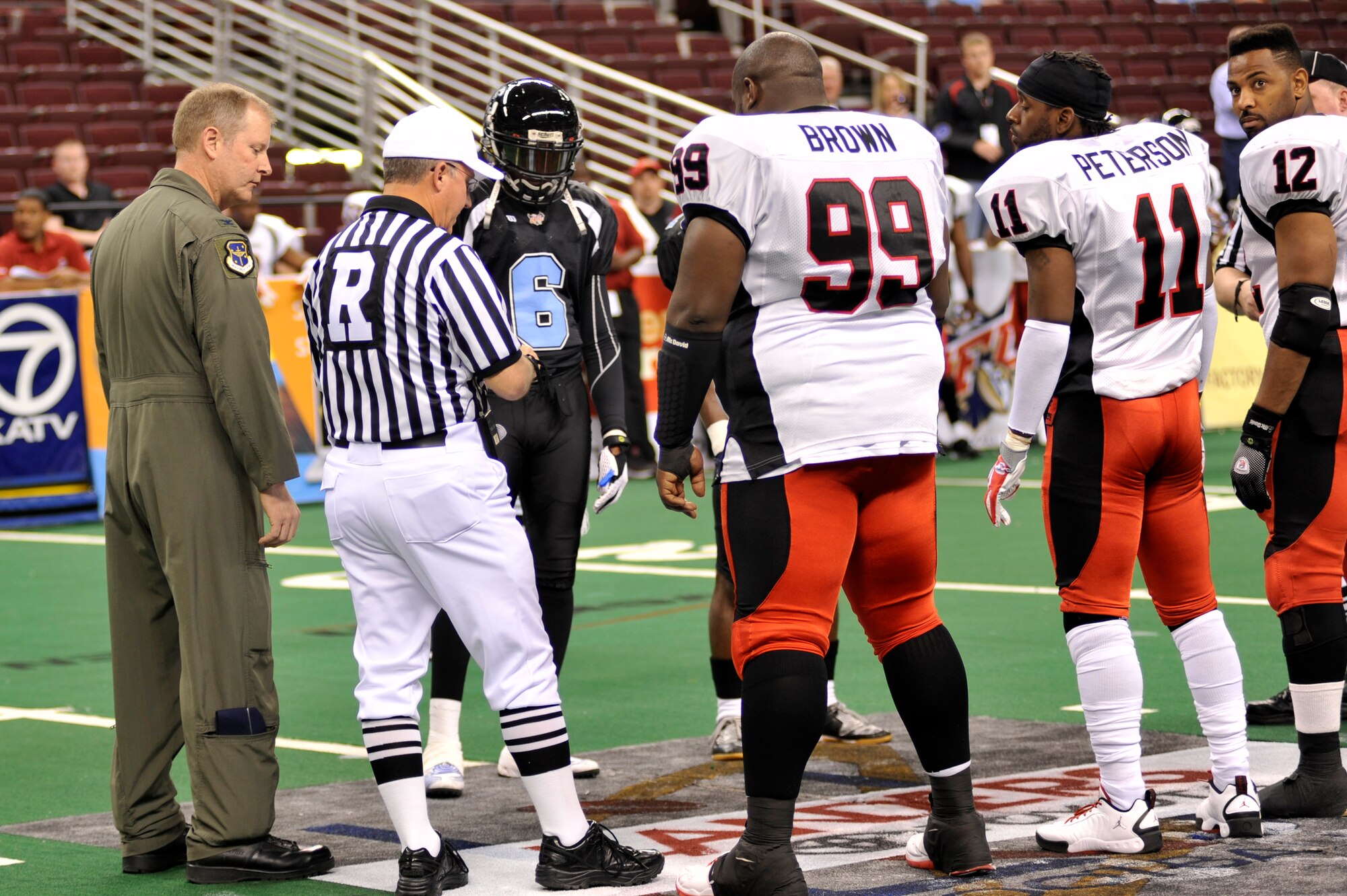Col. Michael Zick, 19th Airlift Wing vice commander, officiates the coin toss at the Arkansas Diamond’s Military Appreciation Night March 27 at Verizon Arena. (U. S. Air Force photo by Senior Airman Christine Clark)
