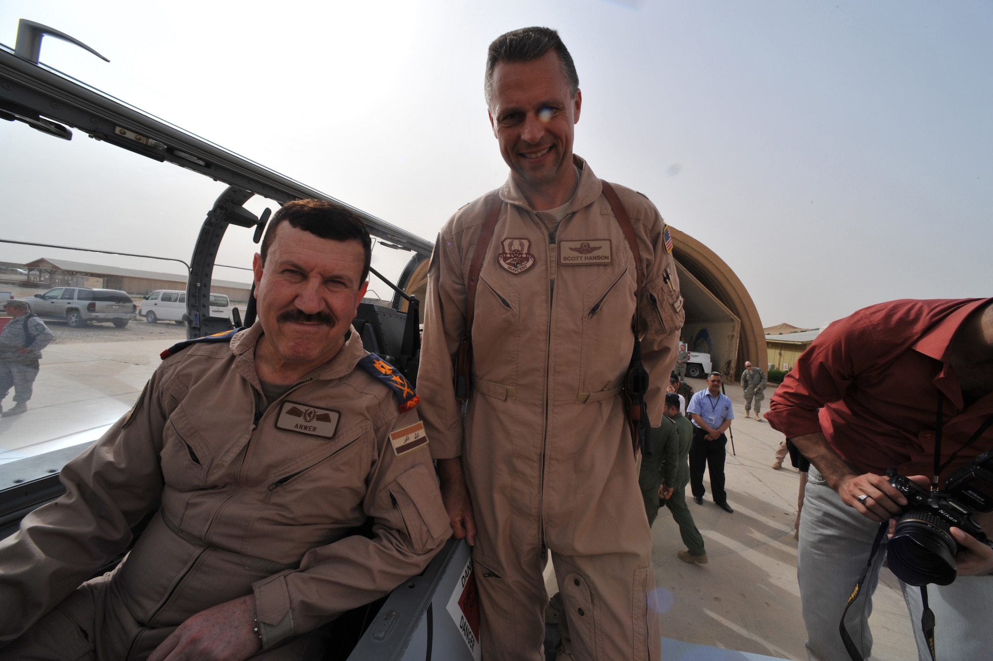 U.S. Air Force Brig. Gen. Scott Hanson, commander of 321st Air Expeditionary Wing and the Iraq Training and Advisory Mission-Air Force, and Lt. Gen. Anwar Hamad Amen Ahmed, Iraqi Air Force commander, pose for a photo inside a new T-6 trainer aircraft at Combat Operations Base Speicher, Iraq, March 11, 2010.  (U.S. Air Force photo/Staff Sgt. Quinton Russ/Released)
