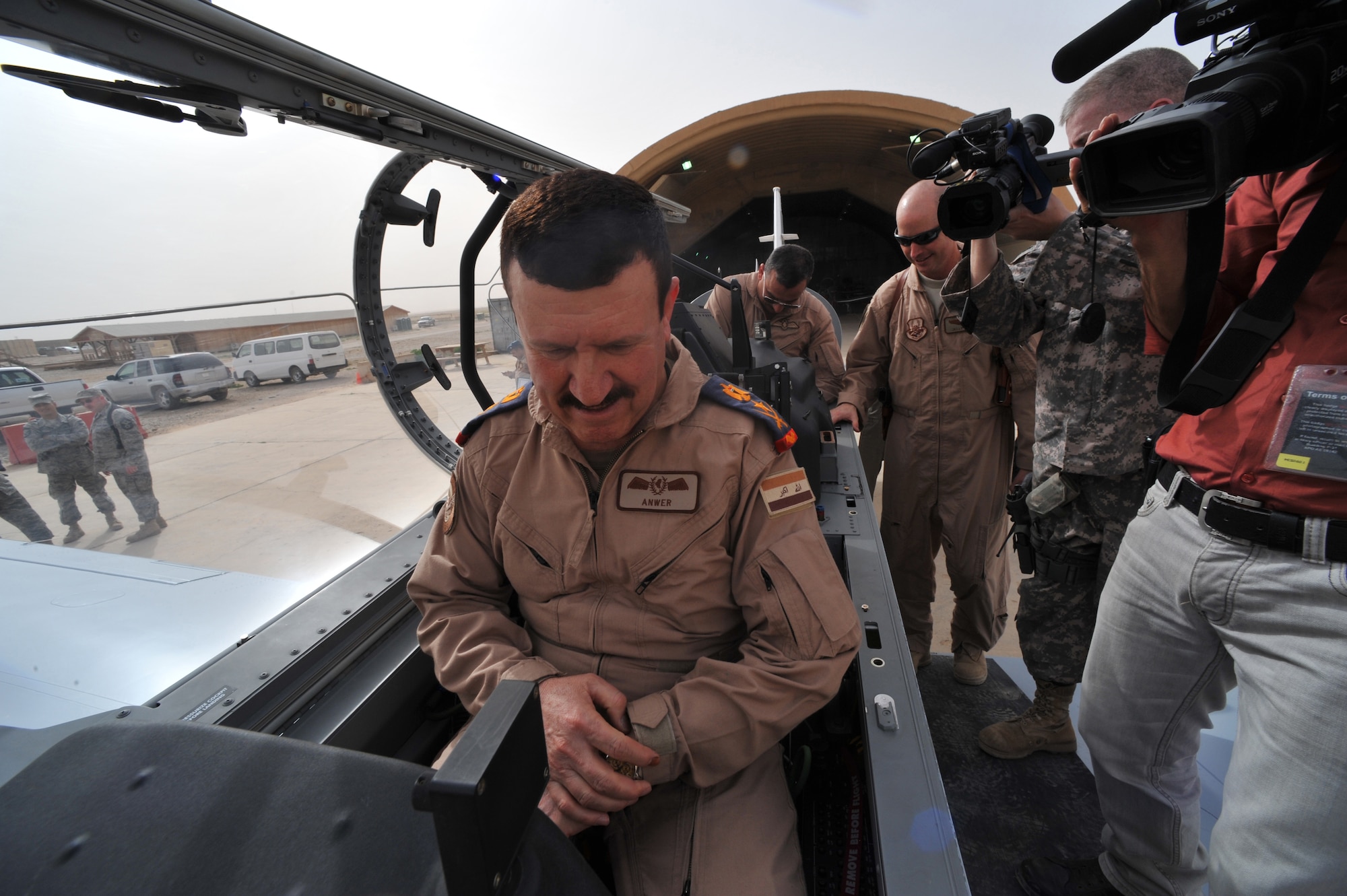 U.S. Air Force Brig. Gen. Scott Hanson, commander of 321st Air Expeditionary Wing and the Iraq Training and Advisory Mission-Air Force, and Lt. Gen. Anwar Hamad Amen Ahmed, Iraqi Air Force commander, pose for a photo inside a new T-6 trainer aircraft at Combat Operations Base Speicher, Iraq, March 11, 2010. (U.S. Air Force photo/Staff Sgt. Quinton Russ/Released)
