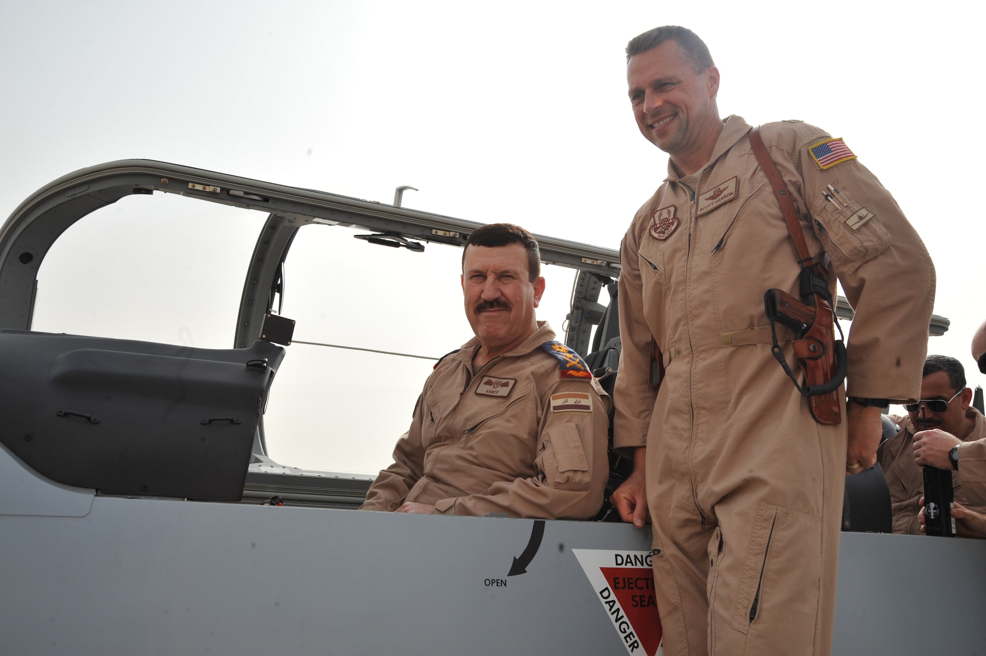 U.S. Air Force Brig. Gen. Scott Hanson, commander of 321st Air Expeditionary Wing and the Iraq Training and Advisory Mission-Air Force, andLt. Gen. Anwar Hamad Amen Ahmed, Iraqi Air Force commander, pose for a photo inside a new T-6 trainer aircraft at Combat Operations Base Speicher, Iraq, March 11, 2010. (U.S. Air Force photo/Staff Sgt. Quinton Russ/Released)
