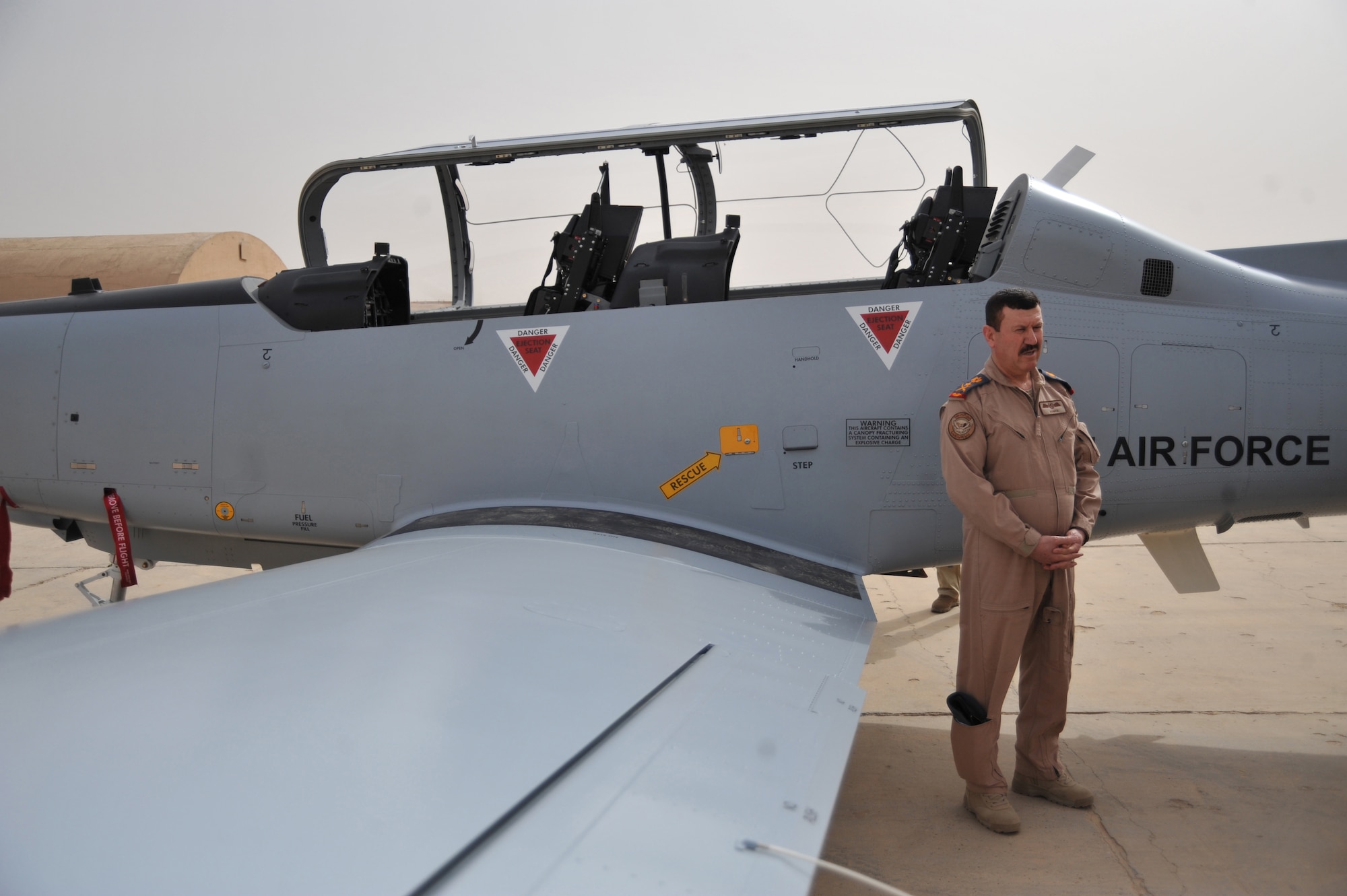 Iraqi Air Force Lt. Gen. Anwar Hamad Amen Ahmed prepares for an interview in front of a T-6 training aircraft at Combat Operations Base Speicher, Iraq, March 11, 2010.  General Amin is the Commander of the Iraqi Air Force.  (U.S. Air Force photo/Staff Sgt. Quinton Russ/released)
