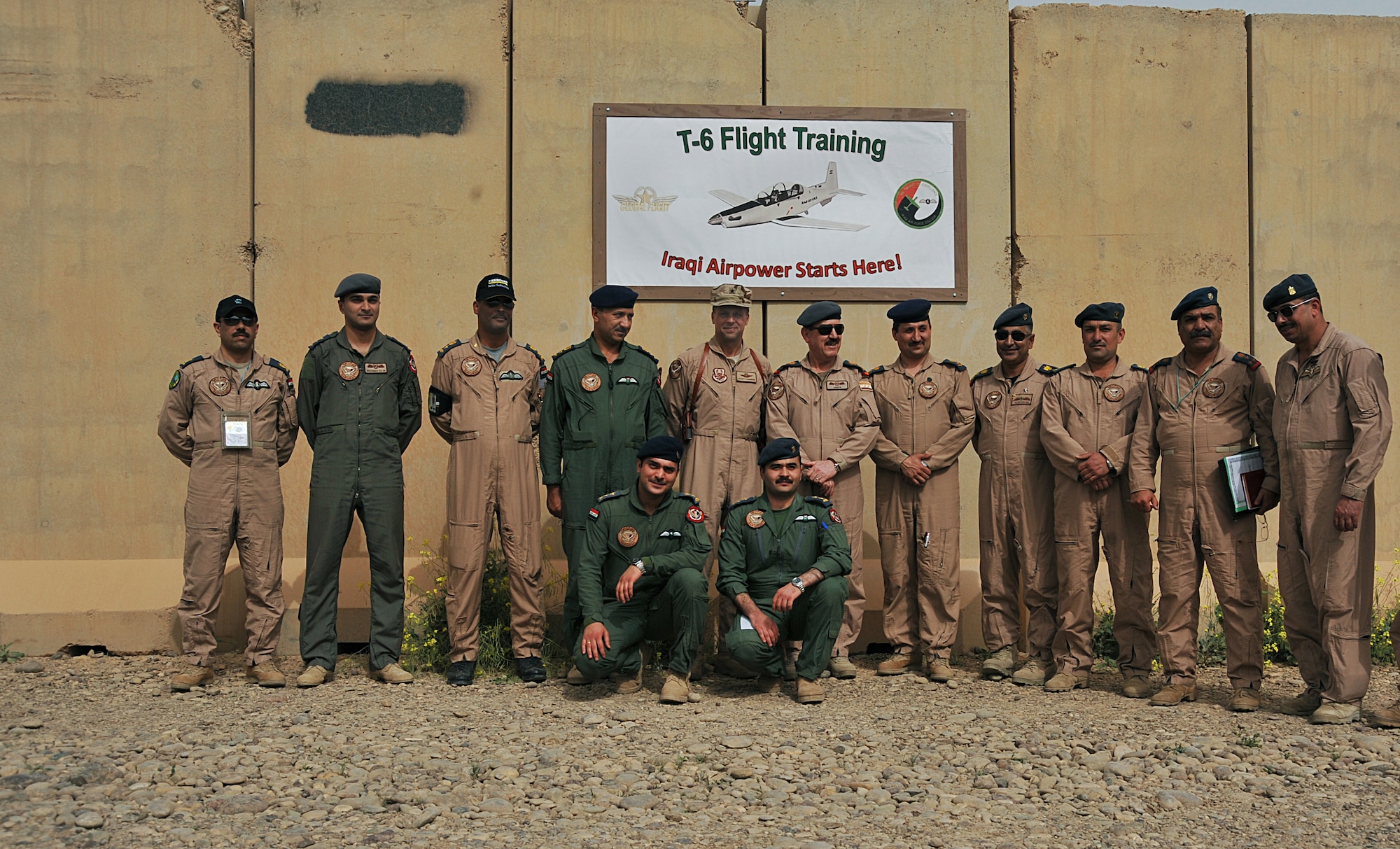 U.S. Air Force Brig. Gen. Scott Hanson, commander of the 321st Air Expeditionary Wing and director of the Iraqi Training and Advisory Mission ? Air Force, and Iraqi Air Force Commander, Lt. Gen. Anwar Hamad Amen Ahmed, pose for a group photo with Iraqi Air Force officers and students in front of the new T-6 Training Squadron at Combat Operations Base Speicher, Iraq, March 11, 2010. (U.S. Air Force photo/Staff Sgt. Quinton Russ/Released)	