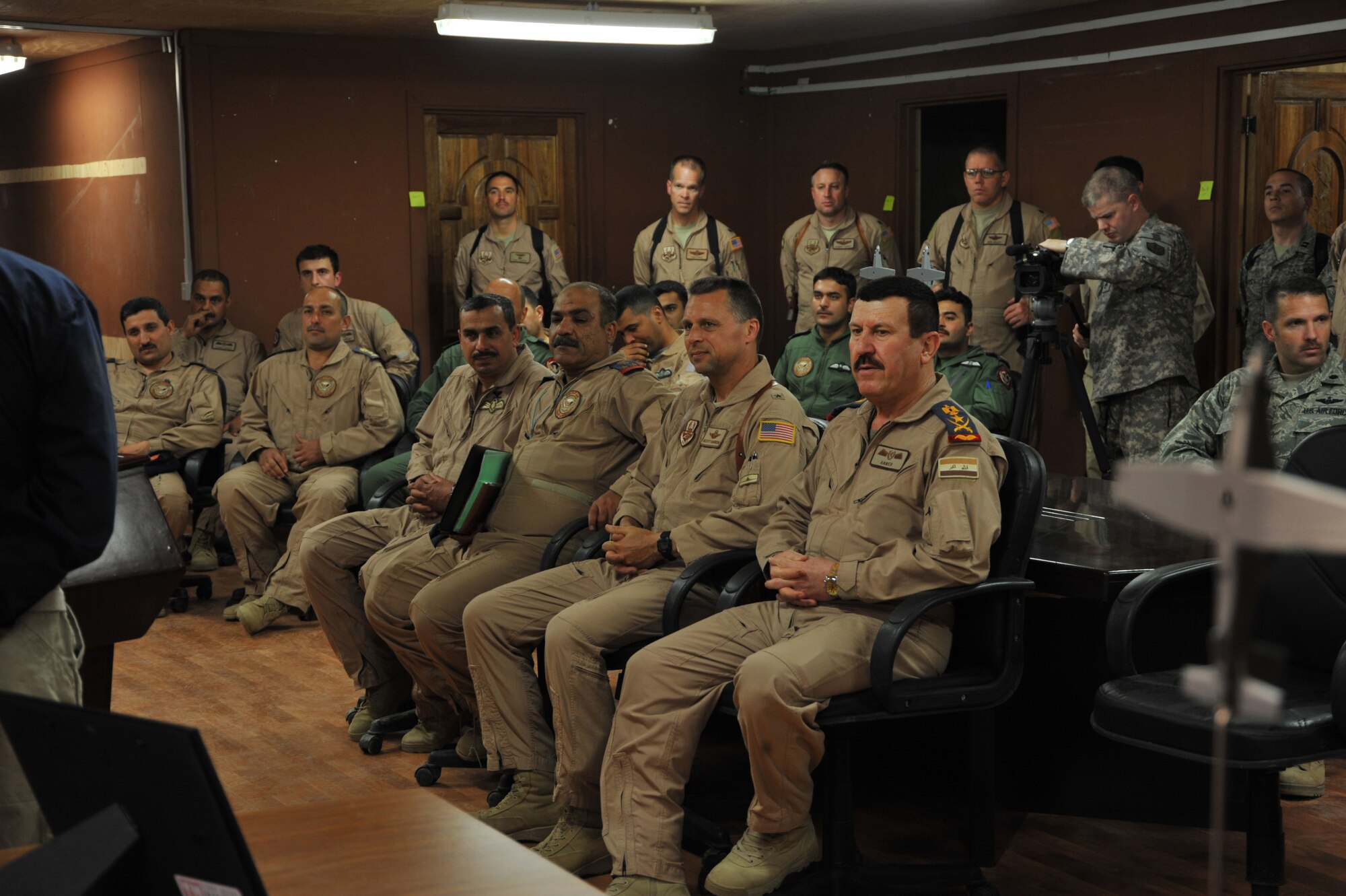 Iraqi Air Force Lt. Gen. Anwar Hamad Amen Ahmed and U.S. Air Force Brig. Gen. Scott Hanson listen to opening remarks at the 52nd Air Expeditionary Advisor Squadron at Combat Operations Base Speicher, Iraq, March 11, 2010.  General Anwar is the commander of the Iraqi Air Force and General Hanson is commander of the 321st Air Expeditionary Wing and director of the Iraqi Training and Advisory Mission ? Air Force.  (U.S. Air Force photo/ Staff Sgt. Quinton Russ/Released)