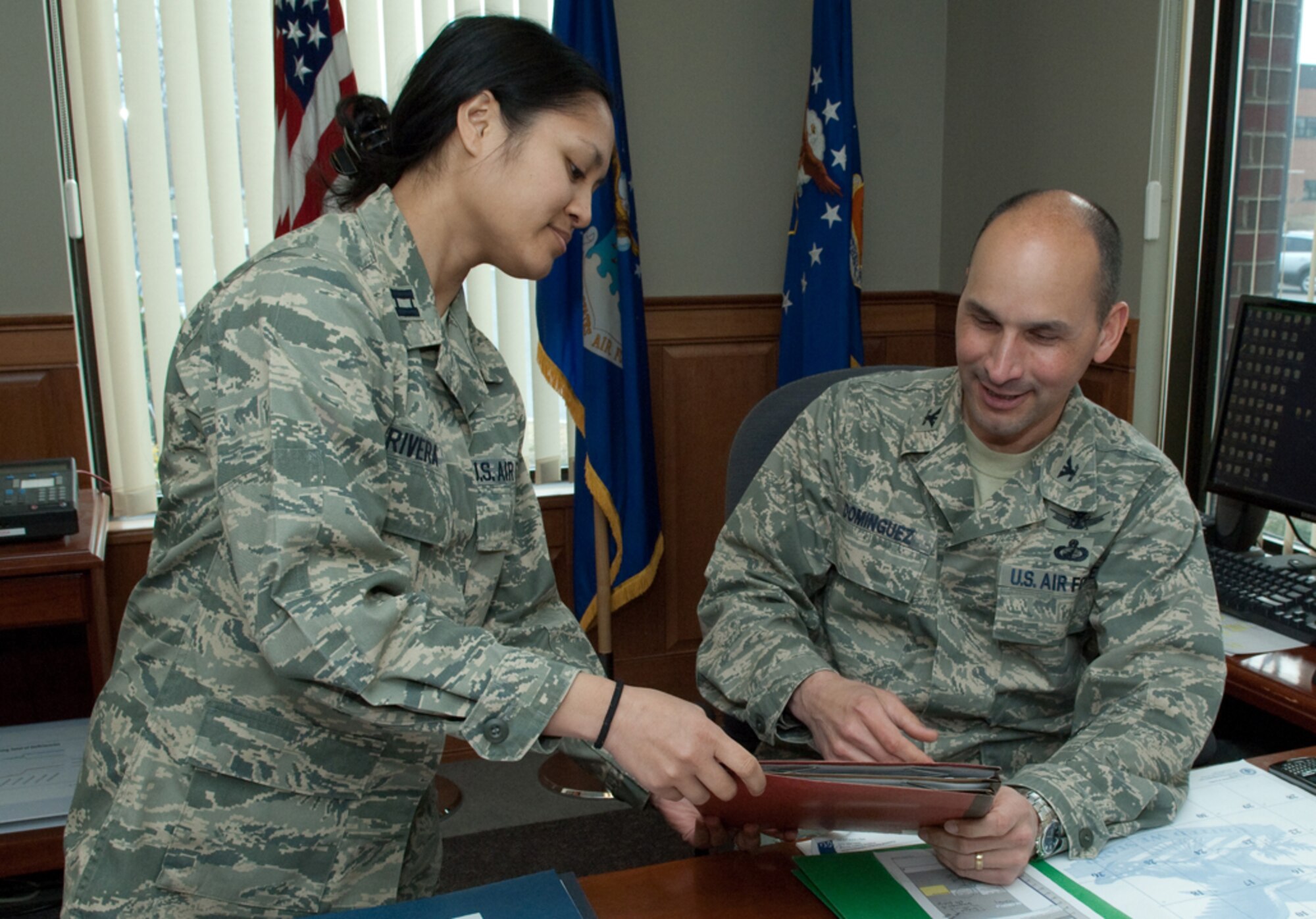 Col. Robert A. Dominguez, 350th Electronic Systems Wing commander, looks
over paperwork with the wing's executive officer, Capt. Jennifer Rivera.
Colonel Dominguez will be retiring from the Air Force Aug. 1 after more than
25 years of service. His retirement ceremony is scheduled for April 2, and
the following week he will depart the local area on permissive TDY and
terminal leave. (Photo by Rick Berry)
