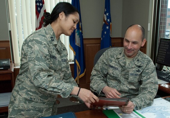 Col. Robert A. Dominguez, 350th Electronic Systems Wing commander, looks
over paperwork with the wing's executive officer, Capt. Jennifer Rivera.
Colonel Dominguez will be retiring from the Air Force Aug. 1 after more than
25 years of service. His retirement ceremony is scheduled for April 2, and
the following week he will depart the local area on permissive TDY and
terminal leave. (Photo by Rick Berry)
