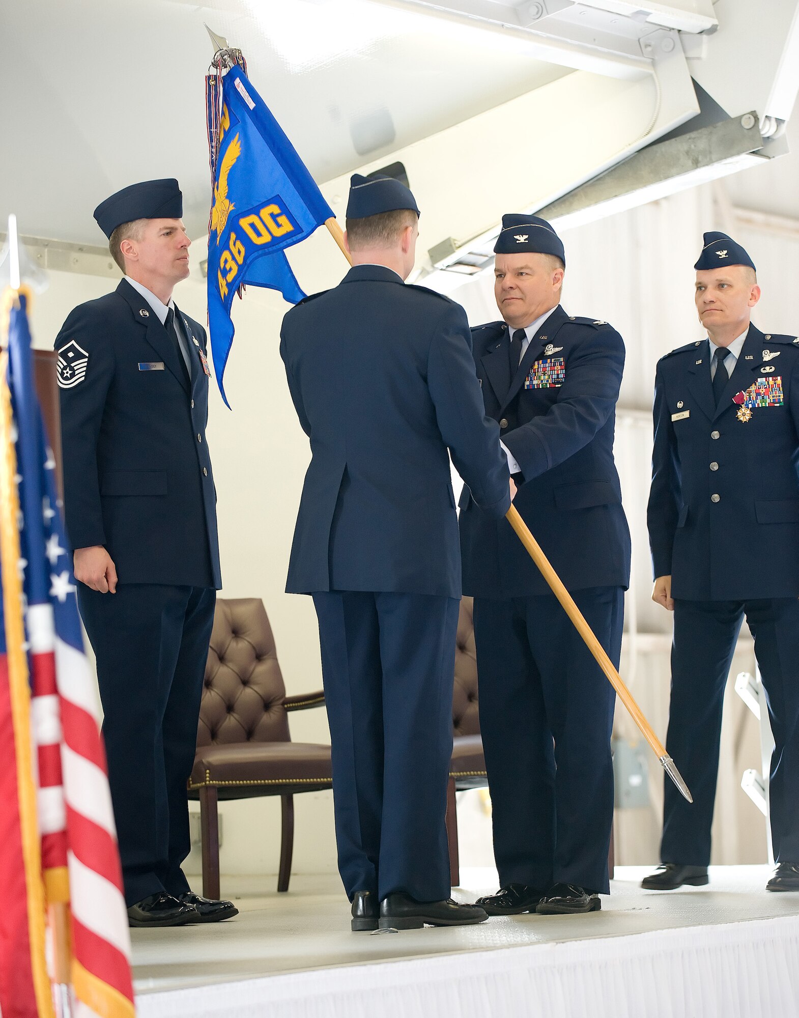(Center left) Col. David Hafer Jr., incoming 436th Operations Group commander, hands the guidon to Col. Manson Morris, 436th Airlift Wing commander. Colonel Hafer assumed command of the 436th OG from Col. David Horton in a ceremony at Hangar 706 March 25. (U.S. Air Force photo/Jason Minto)