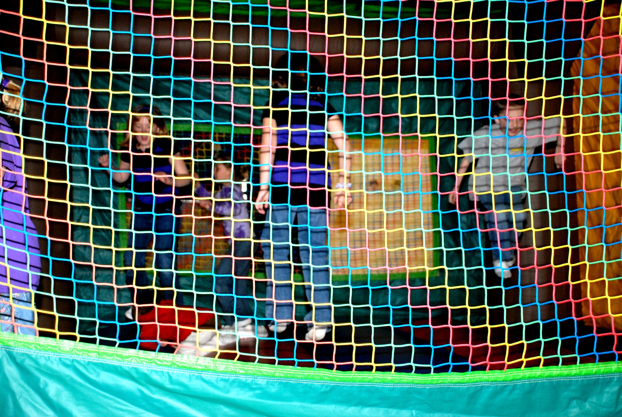 Team Dover children play on the bouncy-castle at a Family Night event at the Landings March 26. The event's goal was to promote family bonding and relaxation.  (U.S. Air Force photo/Airman 1st Class Matthew Hubby)