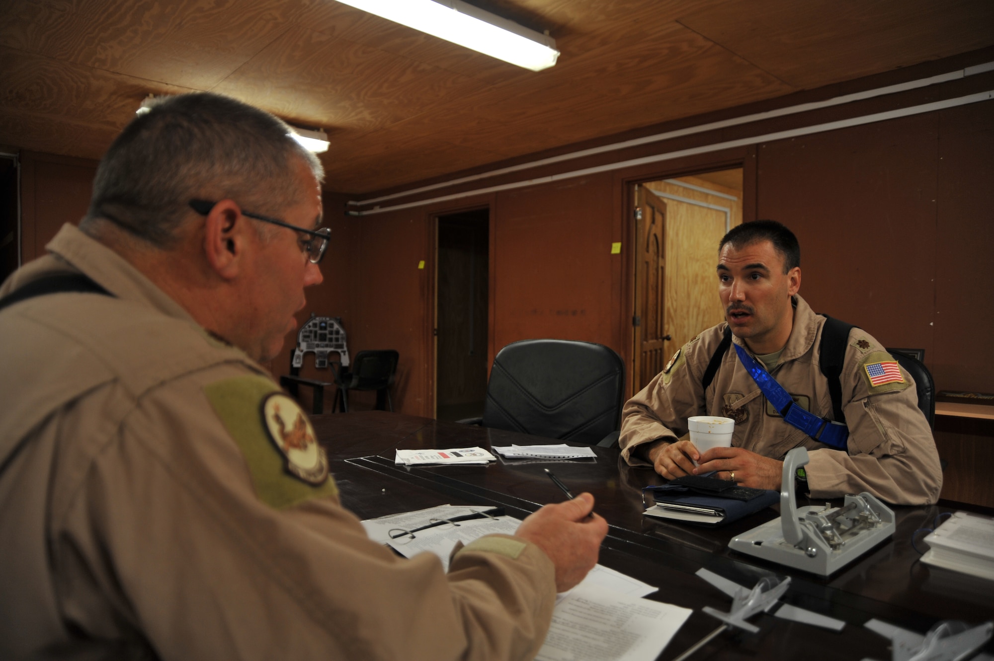 U.S. Air Force pilots Maj. Rick Kelley, left, talks with Maj. Dave Garcia about training scenarios for their Iraqi Air Force student pilots before a T-6 training flight from Combat Operations Base Speicher, Iraq, March 15, 2010.  Maj. Kelley and Garcia are both instructor pilots training the Iraqi Air Force and are deployed from the 559th Flying Training Squadron, Randolph AFB, TX.  This inaugural class will generate the initial cadre of Iraqi Air Force T-6 instructor pilots.  (U.S. Air Force photo/Staff Sgt Quinton Russ/released)