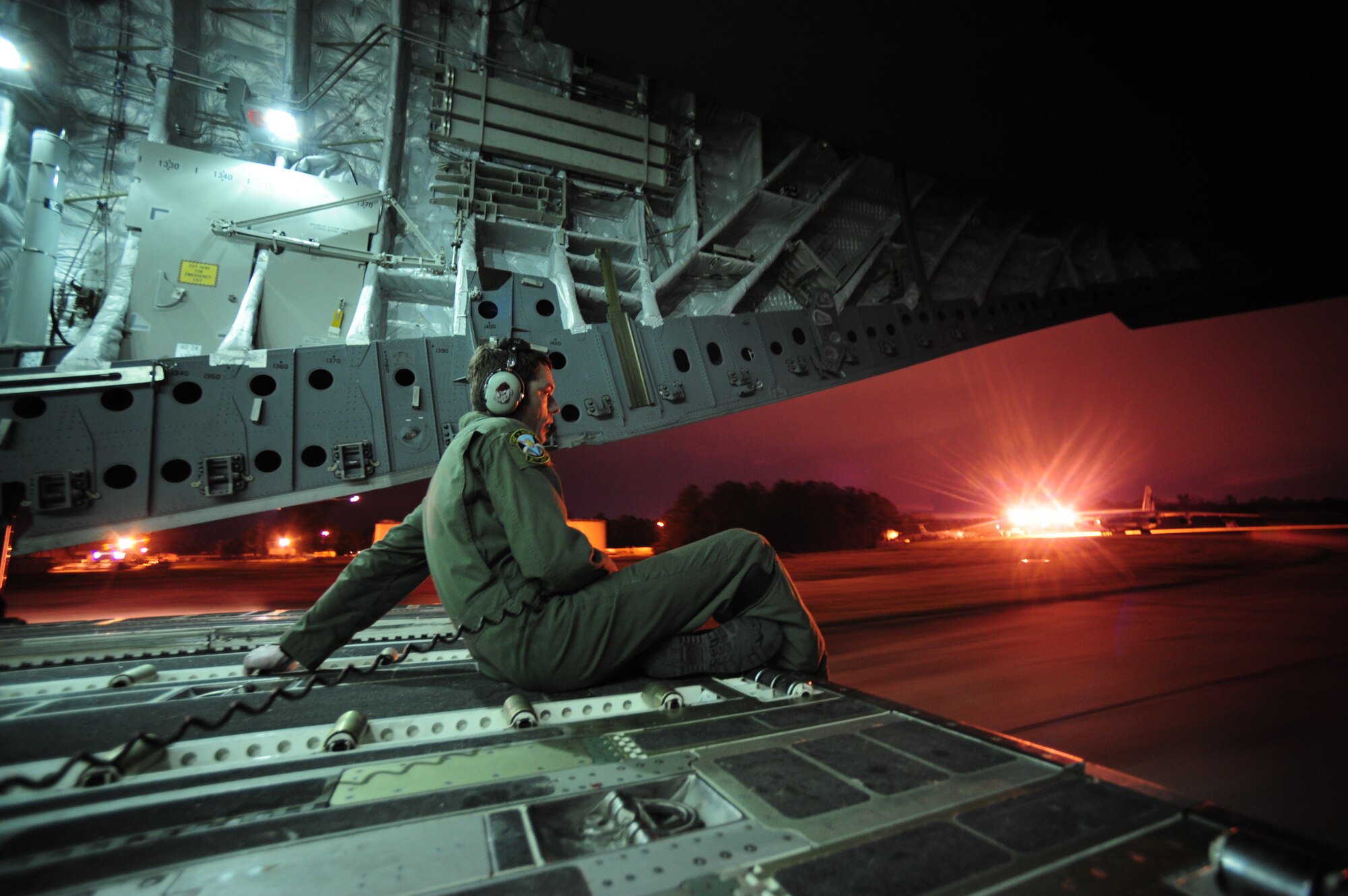 Staff Sgt. Thomas Hughes, a loadmaster assigned to the 317th Airlift Squadron, directs a C-17 Globemaster III aircraft as it backs up in preparation for a combat offload during a training mission at Joint Base Charleston, S.C., March 22, 2010.  He assures that all is clear on the backside of his crew's machine. (U.S. Air Force photo by Staff Sgt. Jacob N. Bailey / Released)
