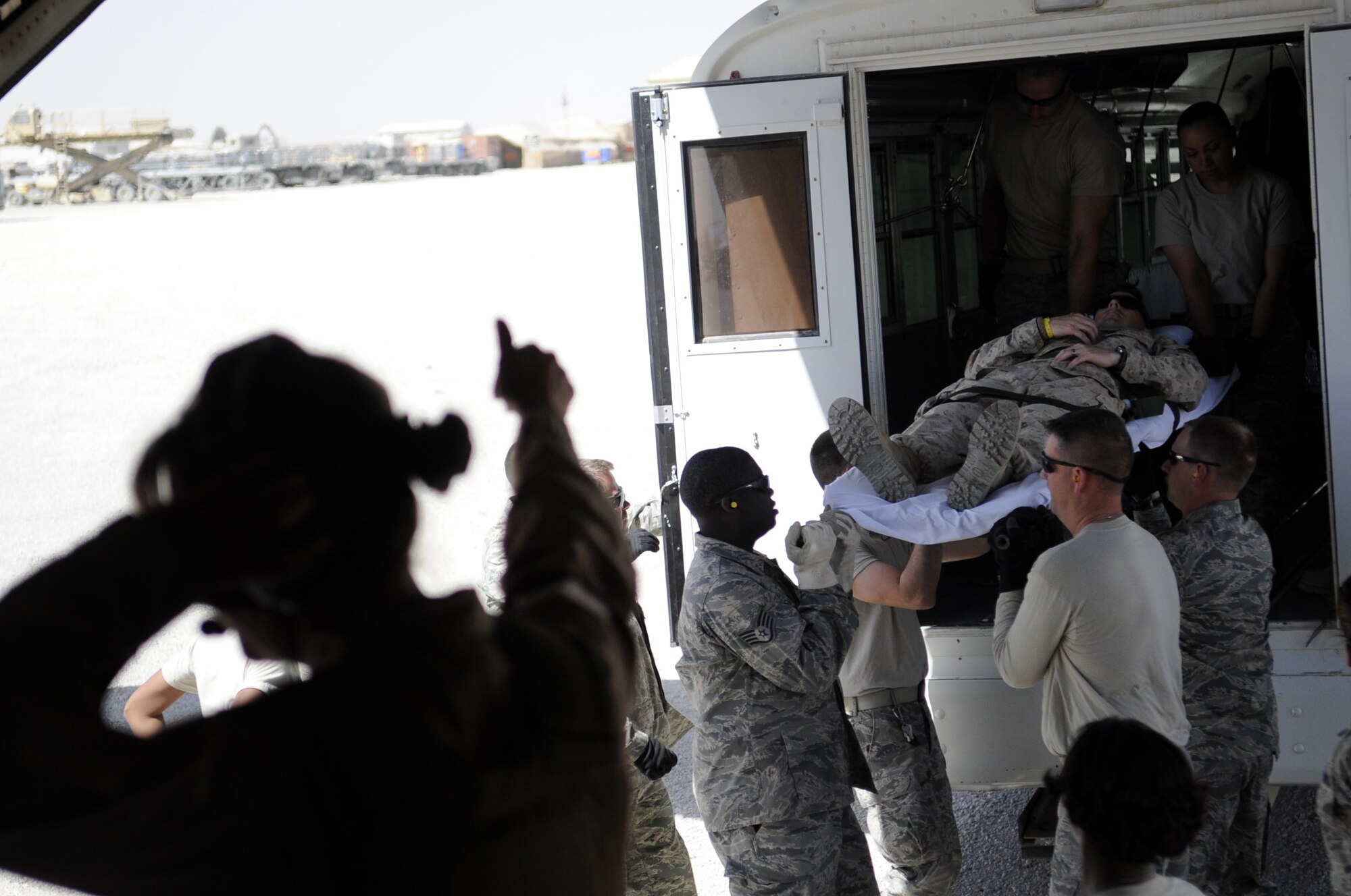 Members from the 451st Aeromedical Evacuation Squadron transport a patient from an ambulance to a C130J in Camp Bastion, Afghanistan March 25.  The patient will be flown to Kandahar Airfield for further treatment.  (U.S. Air Force photo by Senior Airman Nancy Hooks/Released)
