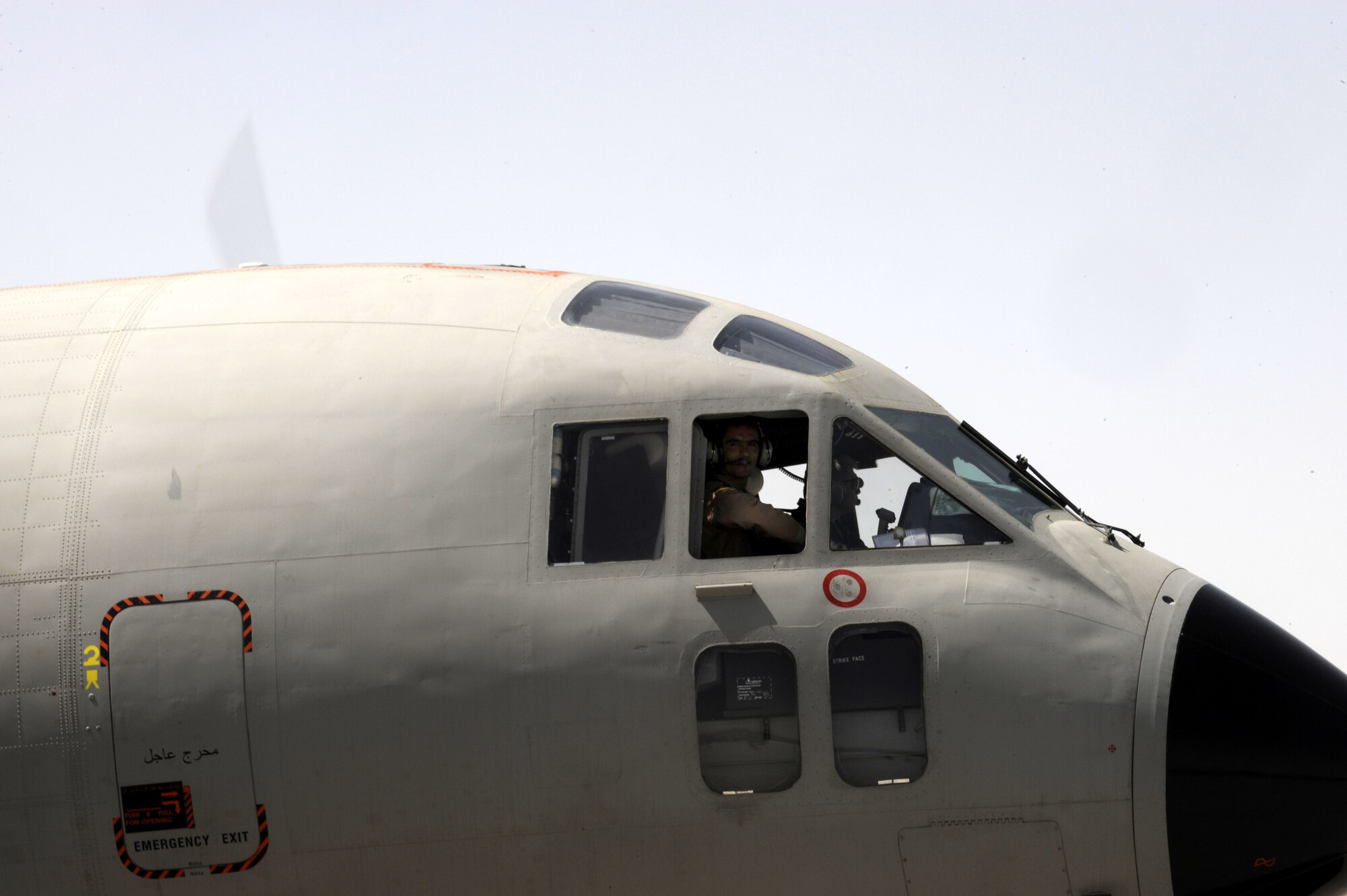 Lt. Col. James Piel,left, 538th Air Expeditionary Advisory Squadron commander and C-27 Spartan pilot-mentor and First Lieutenant Faiz M. Ramaki, an Afghanistan National Army Air Corps (ANAAC) C-27 pilot fly their first operational mission March 24 at Kandahar Airfield, Afghanistan.  Lieutenant Ramaki is the first Afghan pilot to mark in history.  (U.S. Air Force photo by Senior Airman Nancy Hooks/Released)