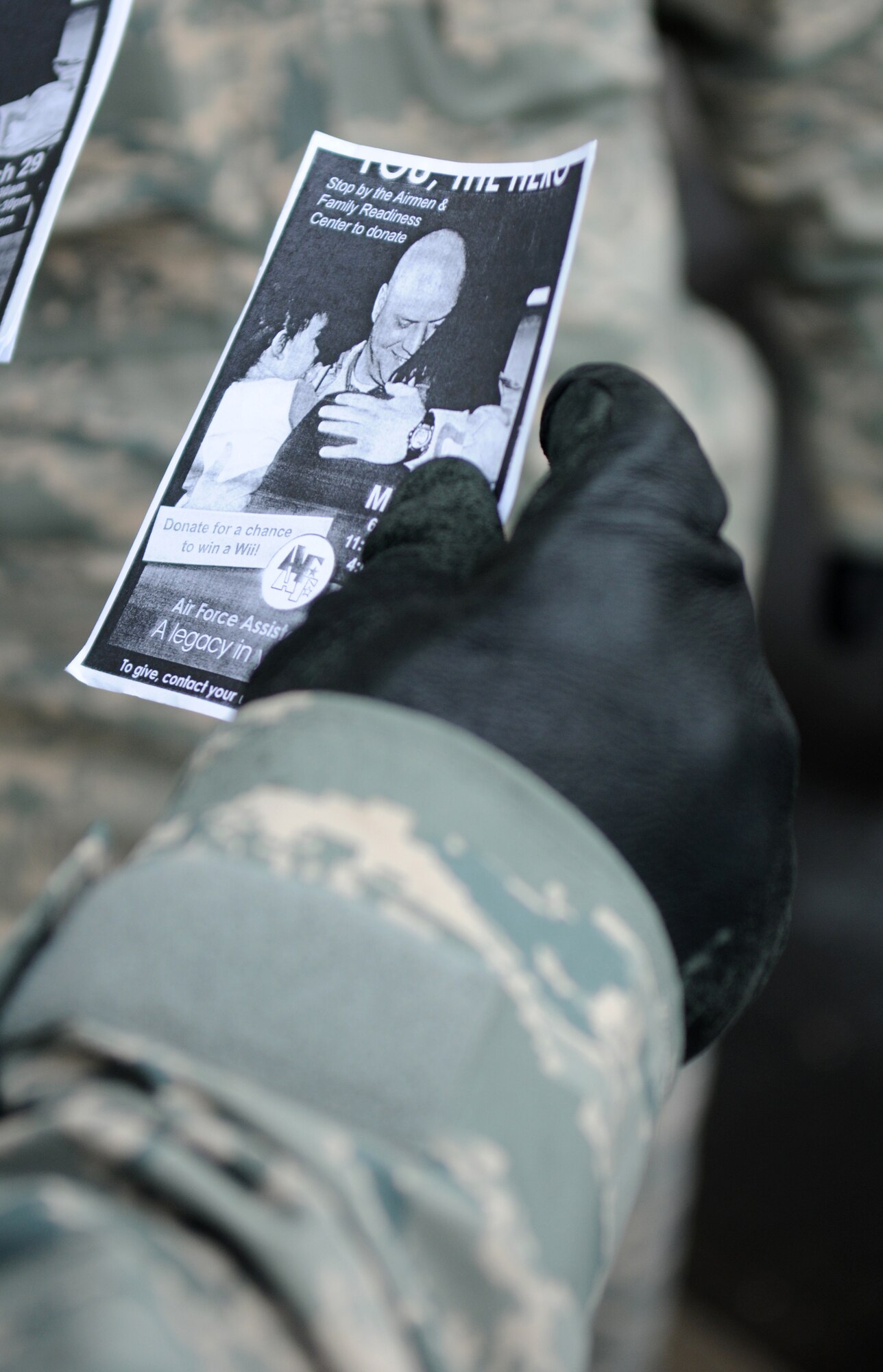 SPANGDAHLEM AIR BASE, Germany – Master Sgt. Dwayne Hill, 52nd Component Maintenance Squadron avionics flight chief, passes out fliers supporting the Air Force Assistance Fund to people entering the base March 29. The 2010 AFAF campaign began March 29 and runs until May 7. (U.S. Air Force photo/Senior Airman Nathanael Callon)