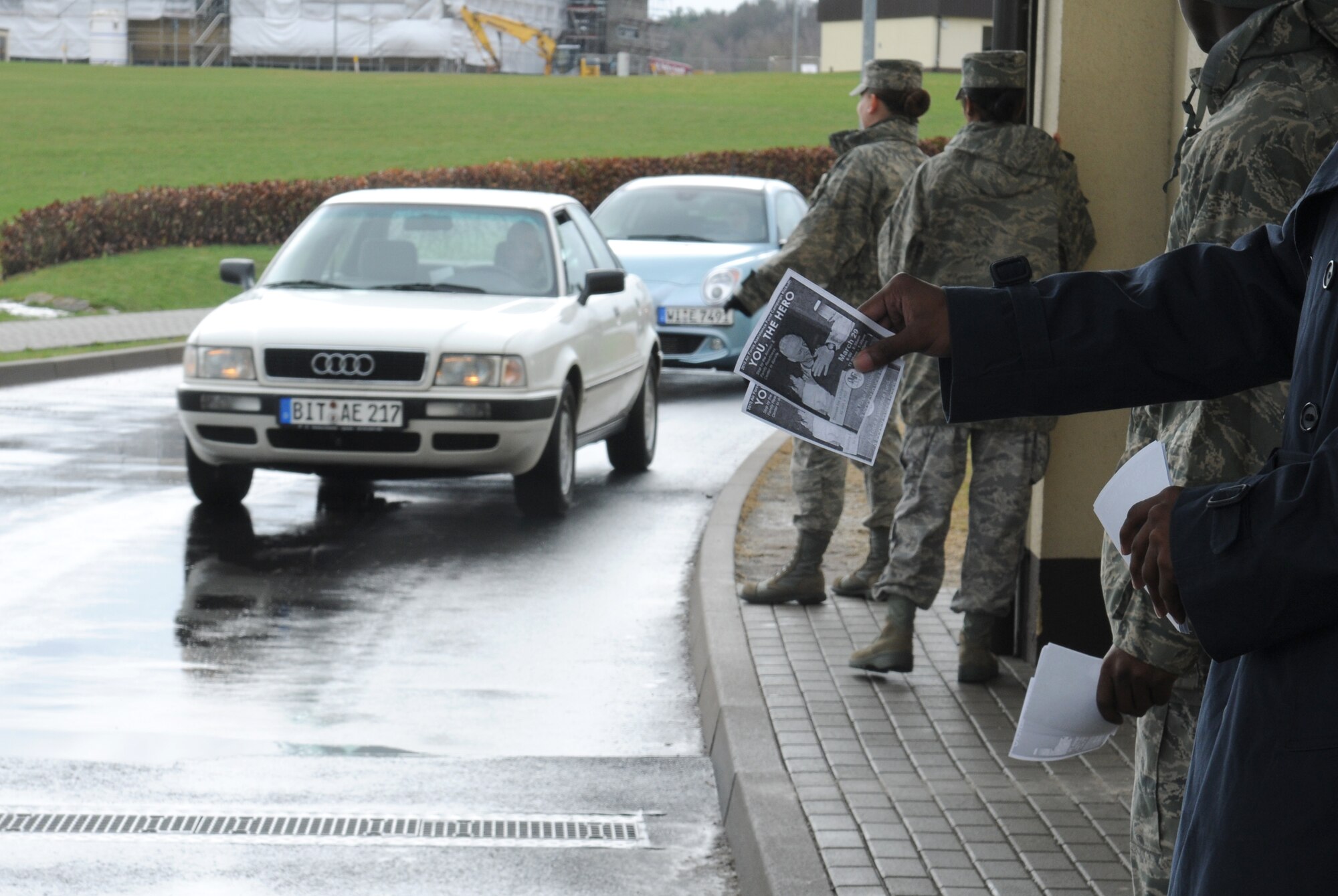 SPANGDAHLEM AIR BASE, Germany – Airmen pass out fliers supporting the Air Force Assistance Fund to people leaving the base March 29. The 2010 AFAF campaign began March 29 and runs until May 7. (U.S. Air Force photo/Senior Airman Nathanael Callon)