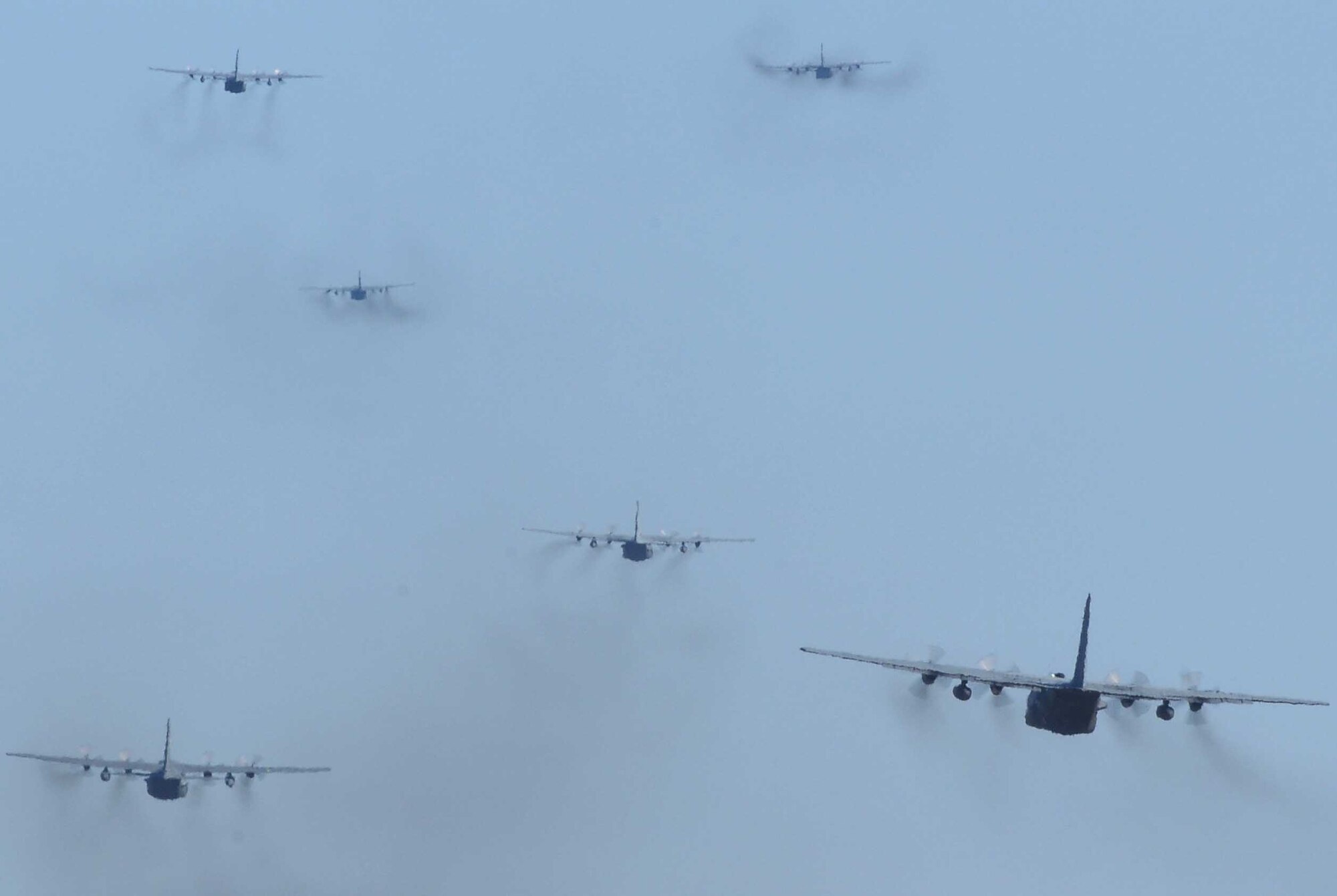 YOKOTA AIR BASE, Japan -- Six C-130H Hercules fly over Yokota Air Base as part of a sevin-aircraft formation launch training exercise Mar. 30. (U.S. Air Force photo/Airman 1st Class Devin Doskey)