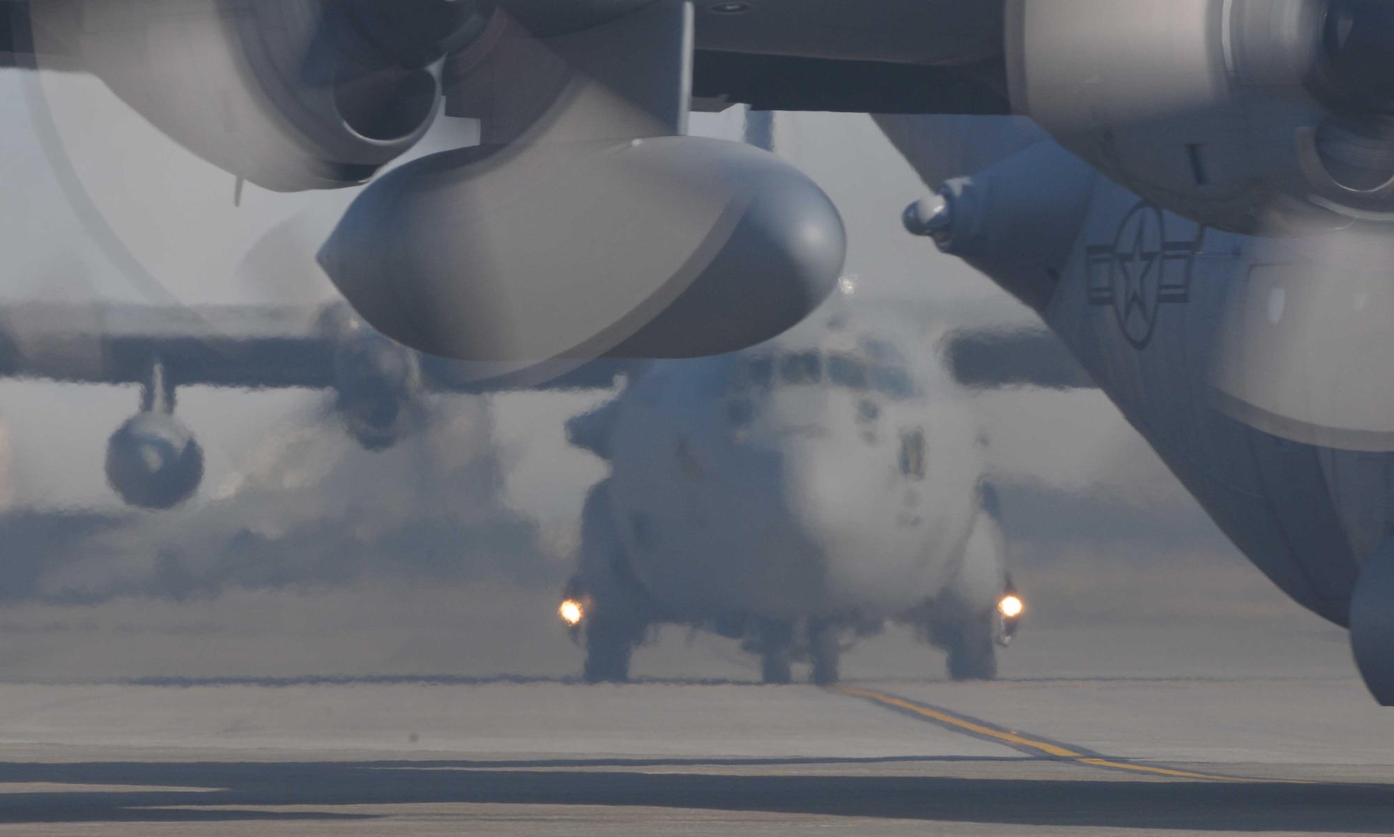 YOKOTA AIR BASE, Japan - - Two C-130H Hercules wait on the flight line prior to launching as part of a seven-aircraft lformation aunch training exercise Mar. 30. (U.S. Air Force photo/Airman 1st Class Devin Doskey)