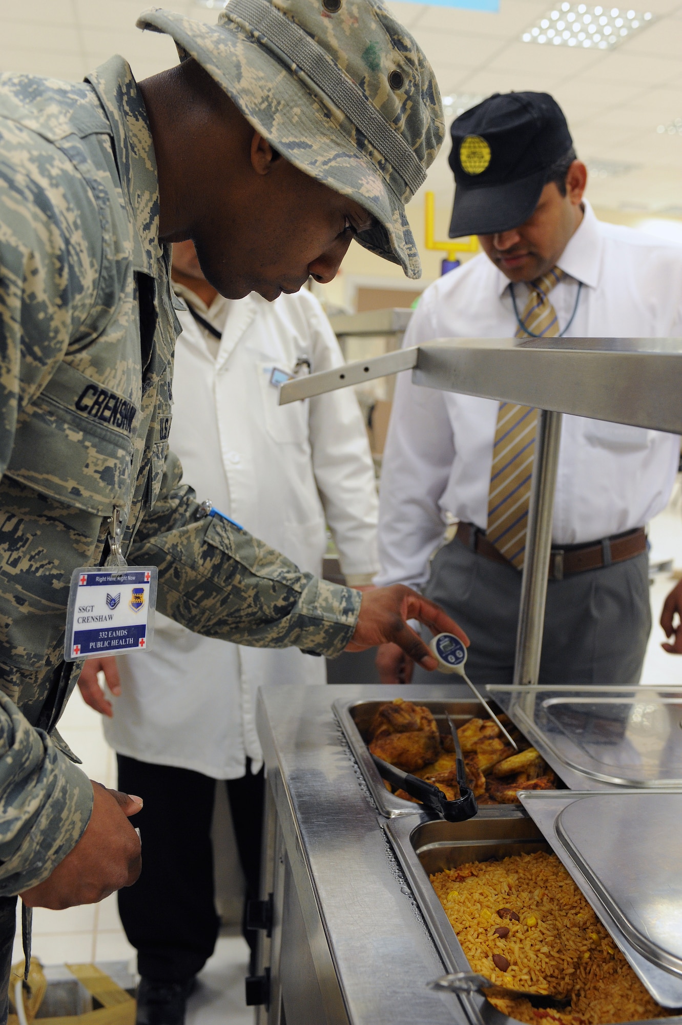Staff Sgt. William Crenshaw, 332nd Aerospace Medicine Squadron public health noncommissioned officer in charge, checks the temperature of the chicken being served in the grab-and-go line during an inspection of Dining Facility Two at Joint Base Balad, Iraq, March 23, 2010. Public Health personnel conduct up to eight no- notice facility inspections every month on JBB to ensure standards are being met. Sergeant Crenshaw is deployed from Lackland AFB, Texas, and is a native of Long Beach, Calif. (U.S. Air Force photo by Master Sgt. Linda C. Miller/Released)